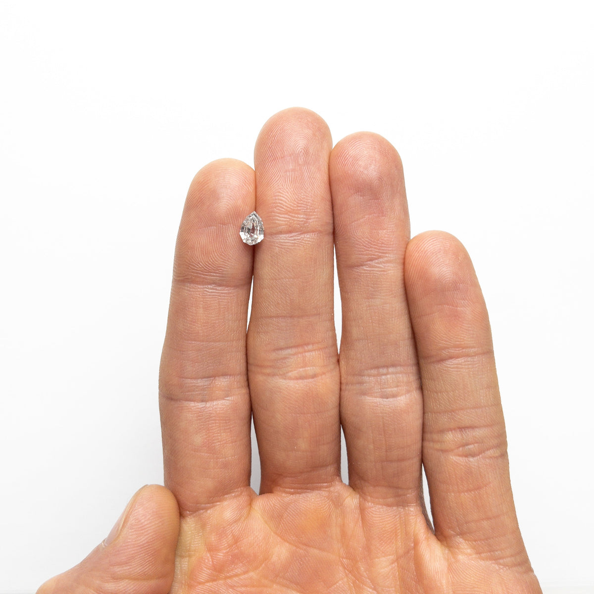 The 0.82ct 7.03x4.86x3.10mm Geo Pear Step Cut 🇨🇦 23255-01 by East London jeweller Rachel Boston | Discover our collections of unique and timeless engagement rings, wedding rings, and modern fine jewellery.