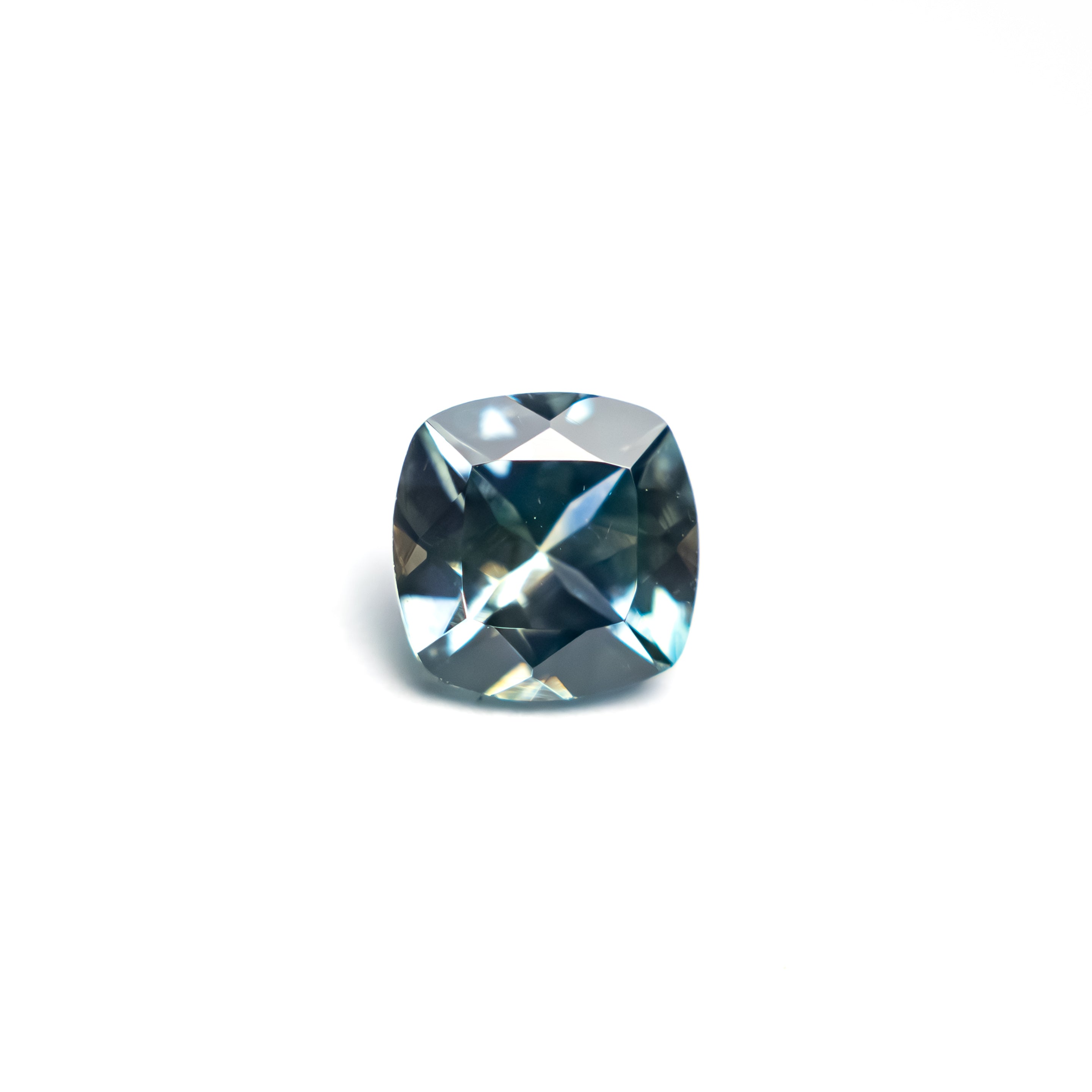 The 0.65ct 5.09x5.06x3.09mm Cushion Brilliant Sapphire 23466-17 by East London jeweller Rachel Boston | Discover our collections of unique and timeless engagement rings, wedding rings, and modern fine jewellery.