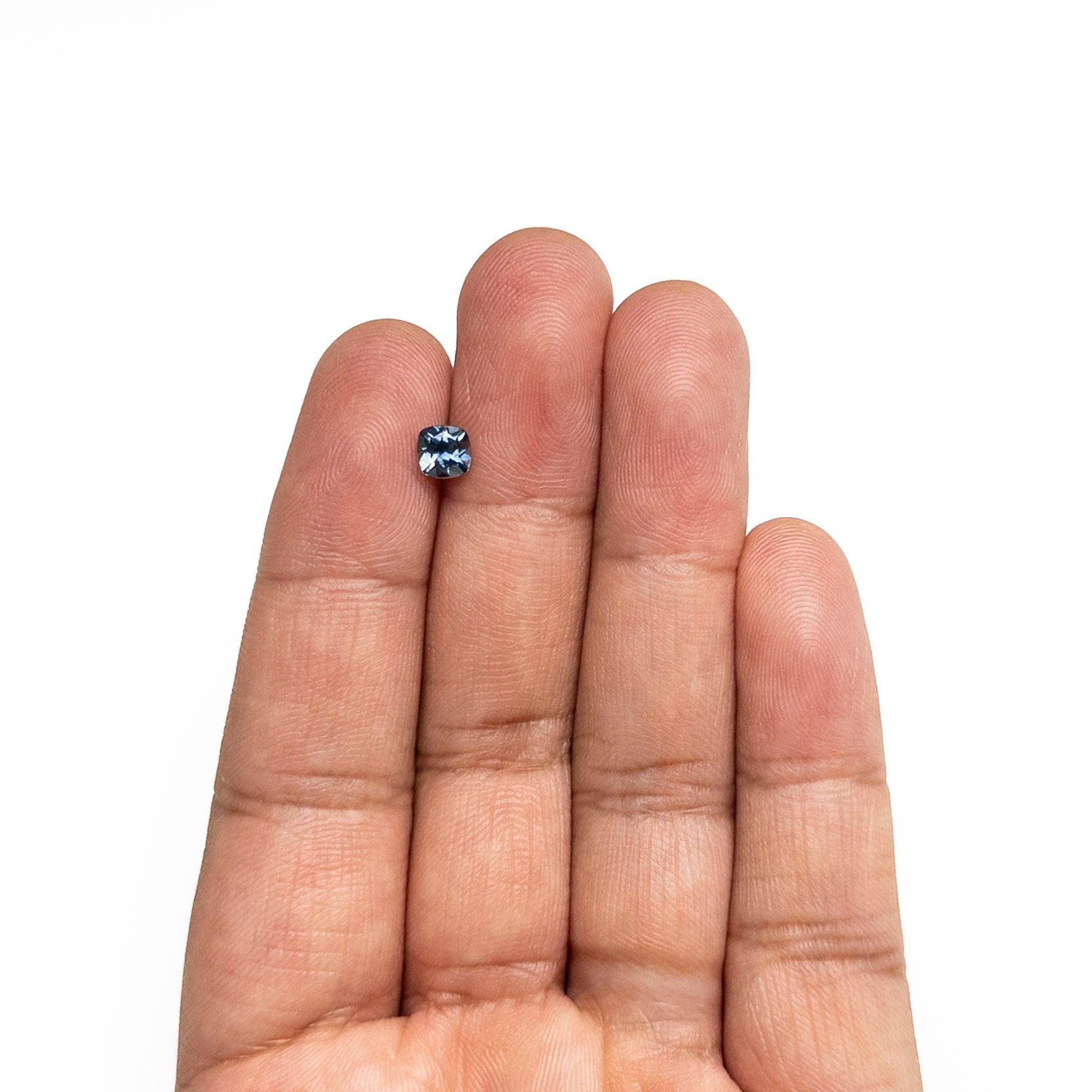 The 0.76ct 5.15x5.08x3.41mm Cushion Brilliant Sapphire 23466-19 by East London jeweller Rachel Boston | Discover our collections of unique and timeless engagement rings, wedding rings, and modern fine jewellery.