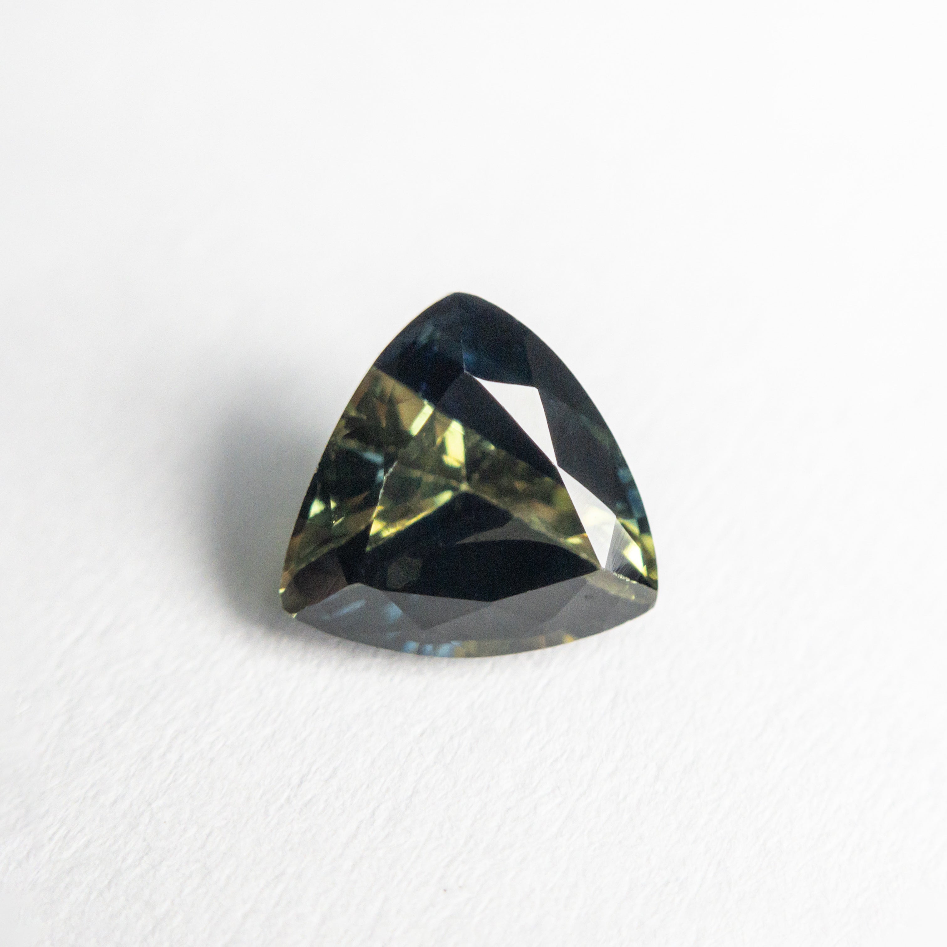 The 1.32ct 6.62x6.50x4.04mm Trillion Brilliant Sapphire 23515-01 by East London jeweller Rachel Boston | Discover our collections of unique and timeless engagement rings, wedding rings, and modern fine jewellery.
