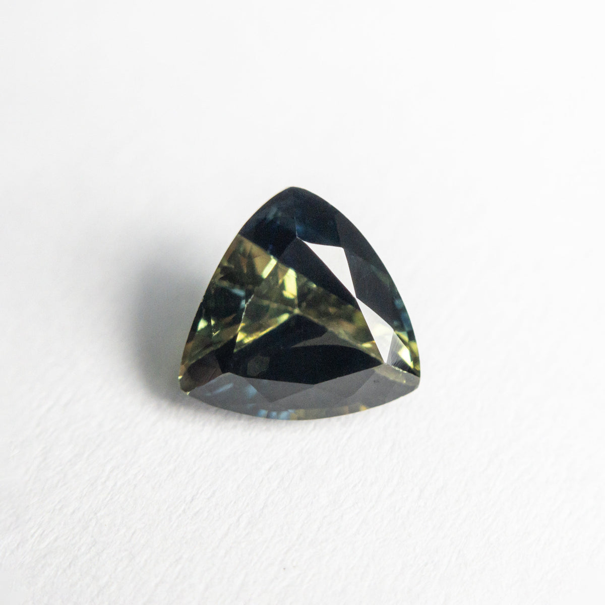 The 1.32ct 6.62x6.50x4.04mm Trillion Brilliant Sapphire 23515-01 by East London jeweller Rachel Boston | Discover our collections of unique and timeless engagement rings, wedding rings, and modern fine jewellery.