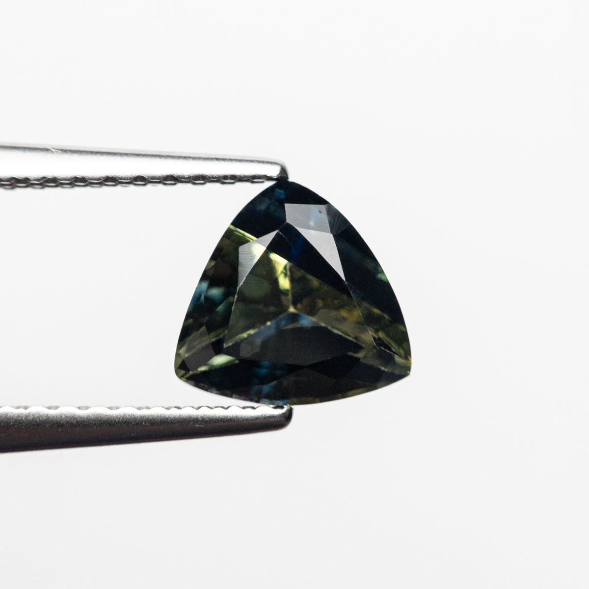 The 1.32ct 6.62x6.50x4.04mm Trillion Brilliant Sapphire 23515-01 by East London jeweller Rachel Boston | Discover our collections of unique and timeless engagement rings, wedding rings, and modern fine jewellery.
