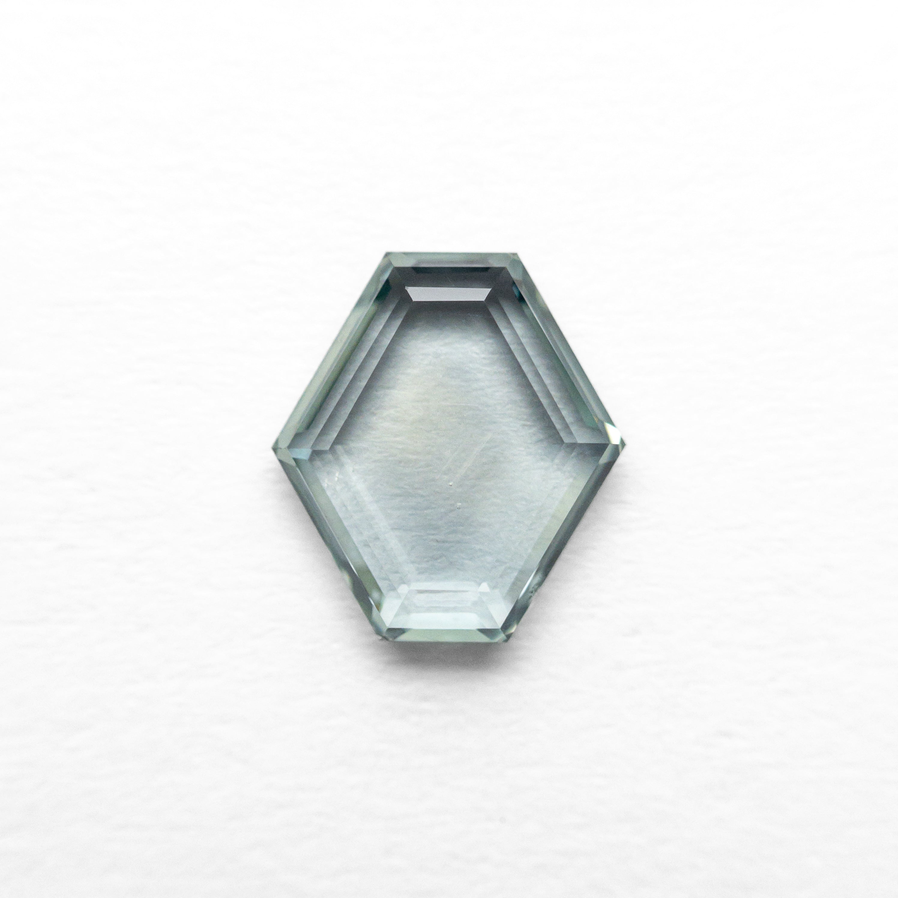 The 1.02ct 7.25x6.59x2.03mm Hexagon Portrait Cut Sapphire 23677-11 by East London jeweller Rachel Boston | Discover our collections of unique and timeless engagement rings, wedding rings, and modern fine jewellery.