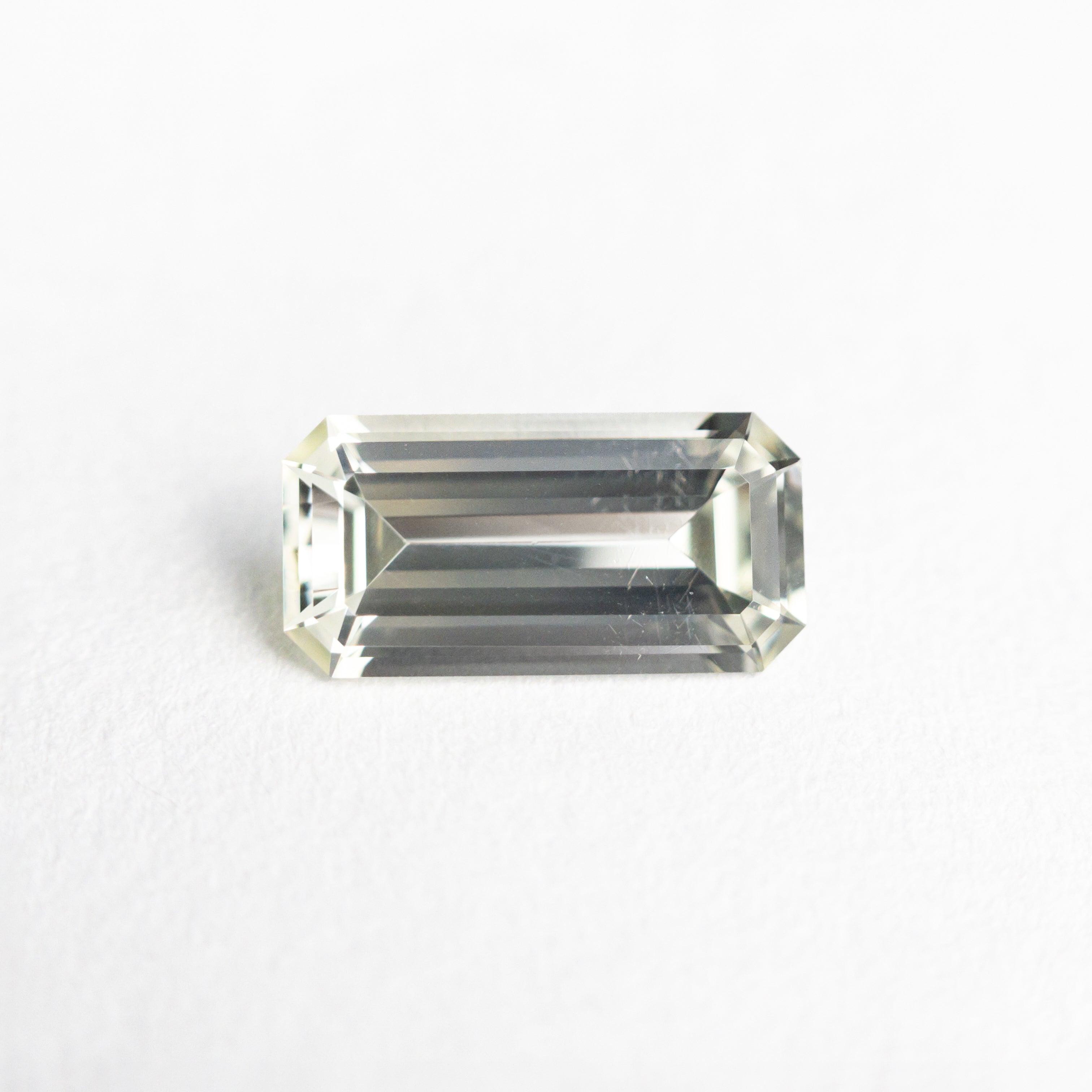 The 0.85ct 7.97x3.98x2.54mm Cut Corner Rectangle Step Cut Sapphire 23773-02 by East London jeweller Rachel Boston | Discover our collections of unique and timeless engagement rings, wedding rings, and modern fine jewellery.