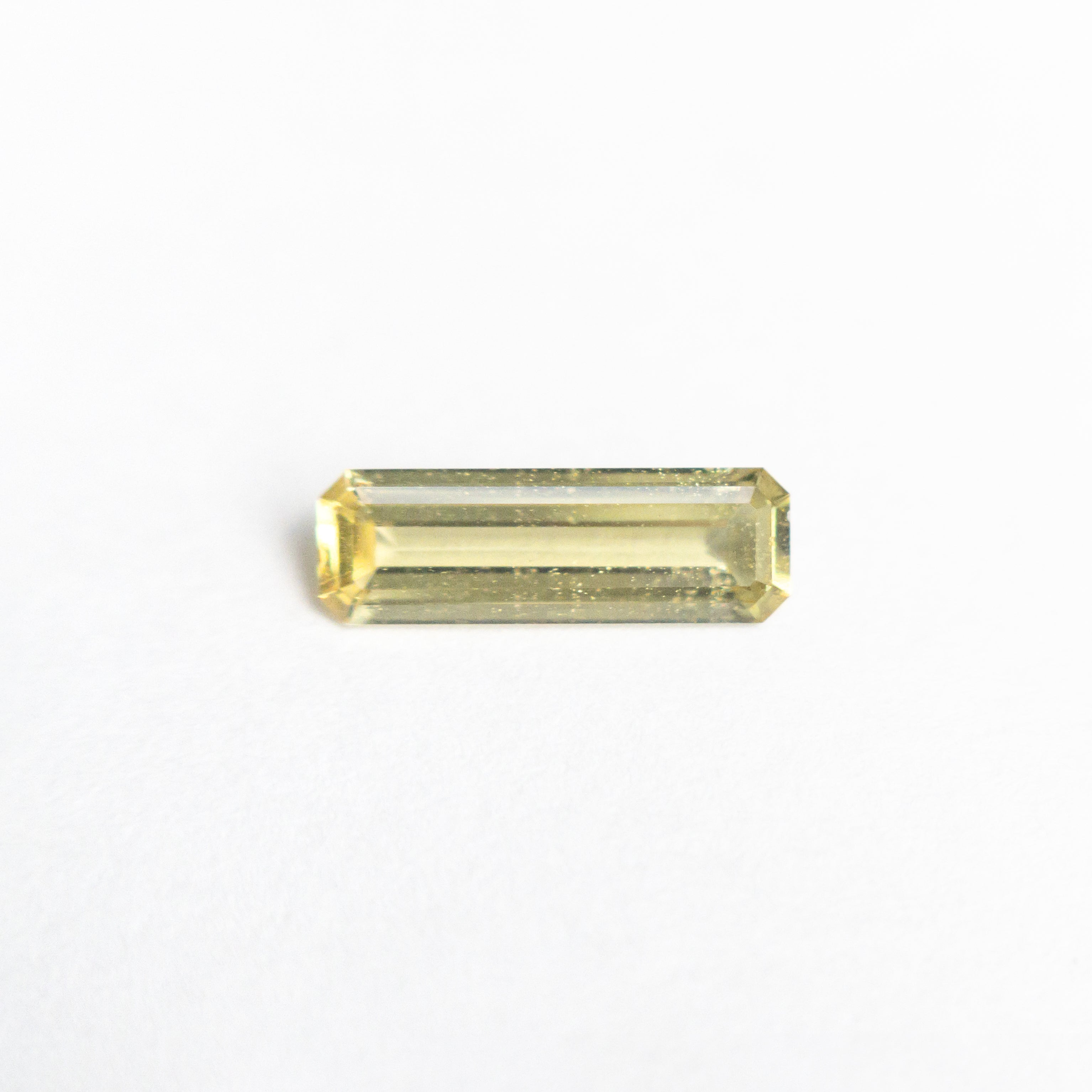 The 0.44ct 8.40x2.79x1.63mm Cut Corner Rectangle Step Cut Sapphire 23780-02 by East London jeweller Rachel Boston | Discover our collections of unique and timeless engagement rings, wedding rings, and modern fine jewellery.