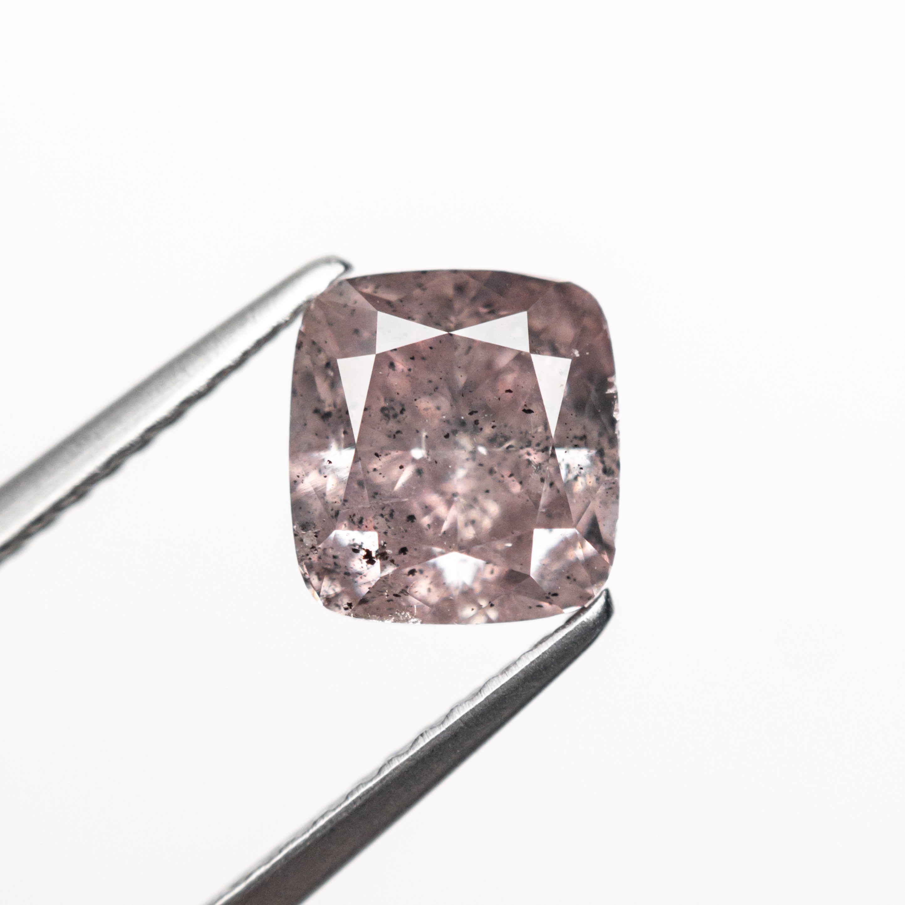 The 2.03ct 7.11x6.65x4.61mm GIA I2 Fancy Brownish Purplish Pink Cushion Brilliant 23911-01 by East London jeweller Rachel Boston | Discover our collections of unique and timeless engagement rings, wedding rings, and modern fine jewellery.