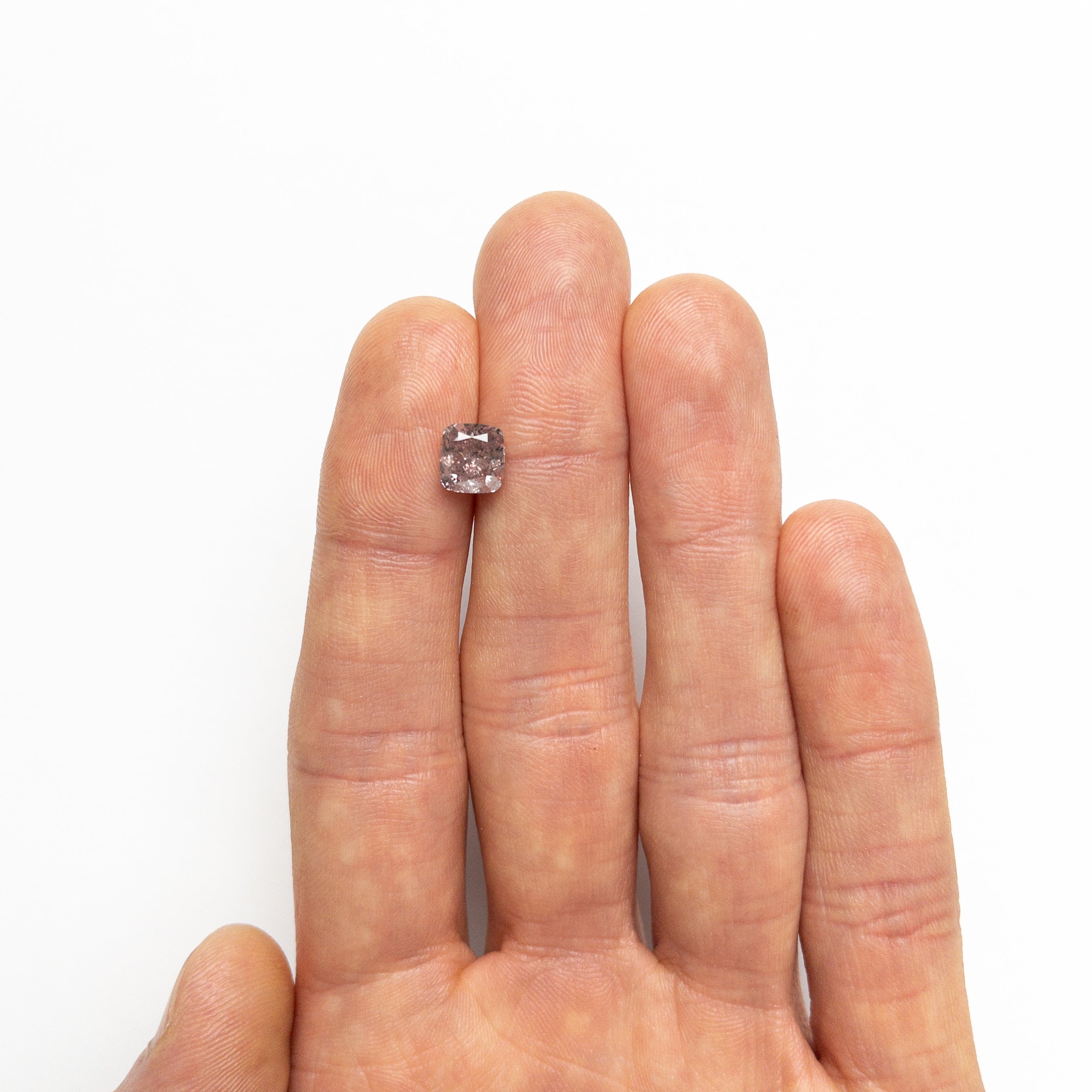 The 2.03ct 7.11x6.65x4.61mm GIA I2 Fancy Brownish Purplish Pink Cushion Brilliant 23911-01 by East London jeweller Rachel Boston | Discover our collections of unique and timeless engagement rings, wedding rings, and modern fine jewellery.