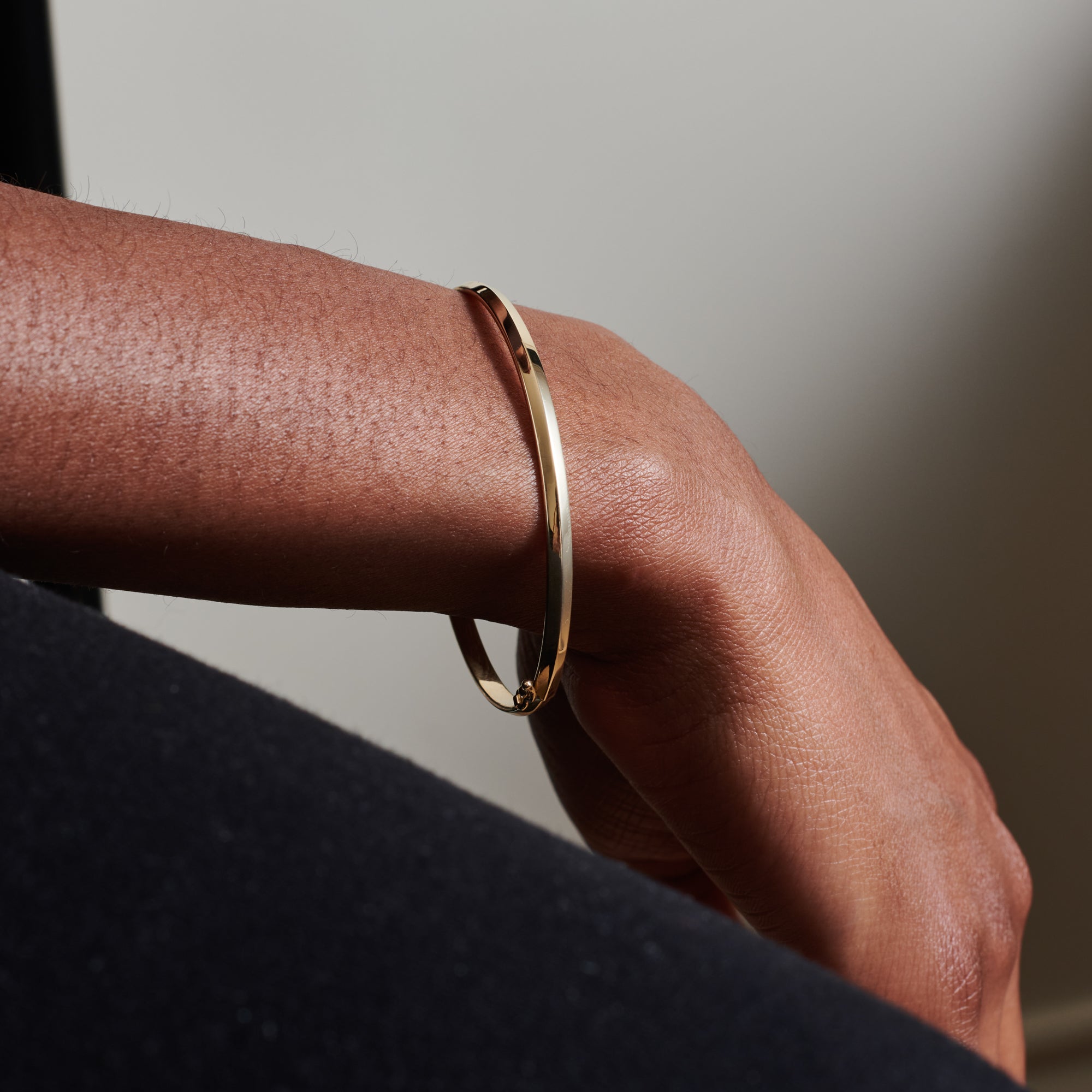 The Single Knife Edge Bangle by East London jeweller Rachel Boston | Discover our collections of unique and timeless engagement rings, wedding rings, and modern fine jewellery.