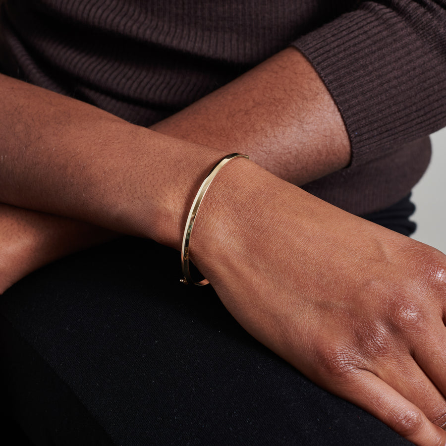 The Single Knife Edge Bangle by East London jeweller Rachel Boston | Discover our collections of unique and timeless engagement rings, wedding rings, and modern fine jewellery. - Rachel Boston Jewellery