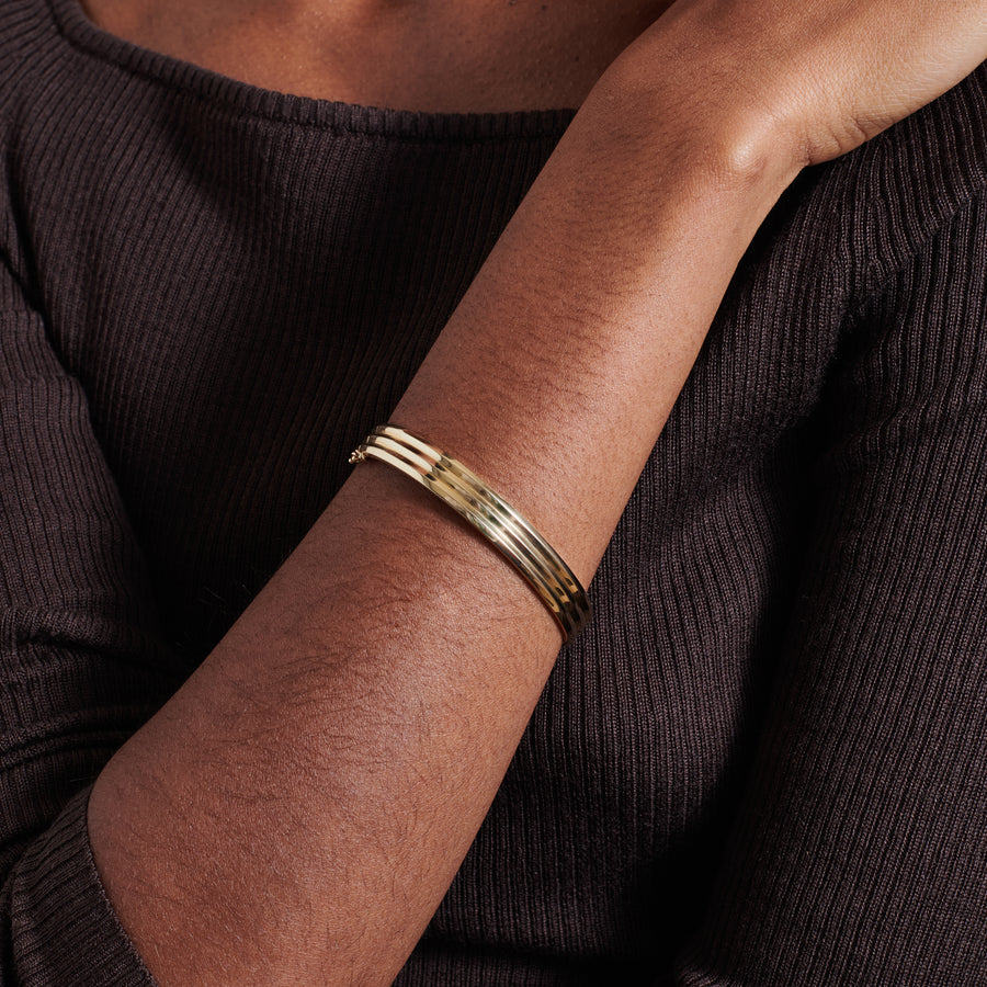 The Heavy Triple Knife Edge Bangle by East London jeweller Rachel Boston | Discover our collections of unique and timeless engagement rings, wedding rings, and modern fine jewellery. - Rachel Boston Jewellery