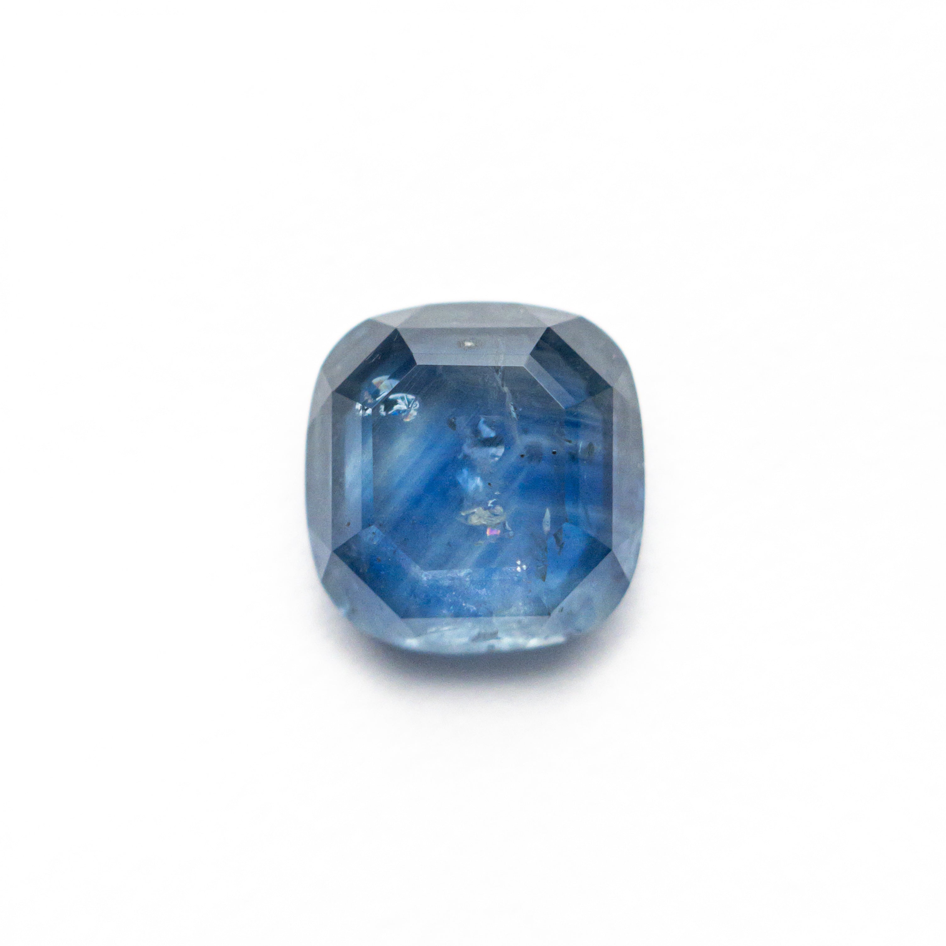 The 1.98ct 7.26x7.01x3.24mm Cushion Portrait Cut Sapphire 24197-02 by East London jeweller Rachel Boston | Discover our collections of unique and timeless engagement rings, wedding rings, and modern fine jewellery.