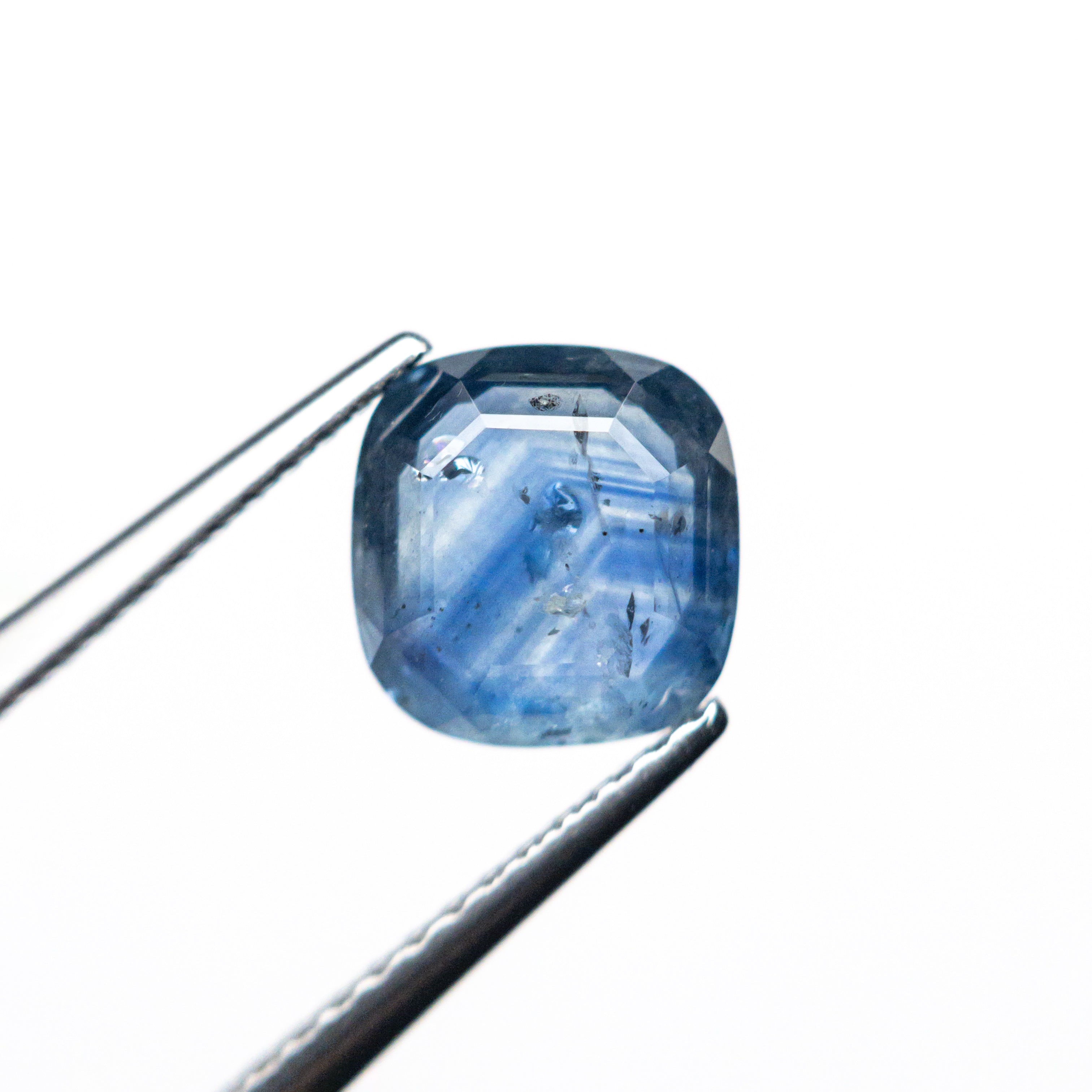 The 1.98ct 7.26x7.01x3.24mm Cushion Portrait Cut Sapphire 24197-02 by East London jeweller Rachel Boston | Discover our collections of unique and timeless engagement rings, wedding rings, and modern fine jewellery.