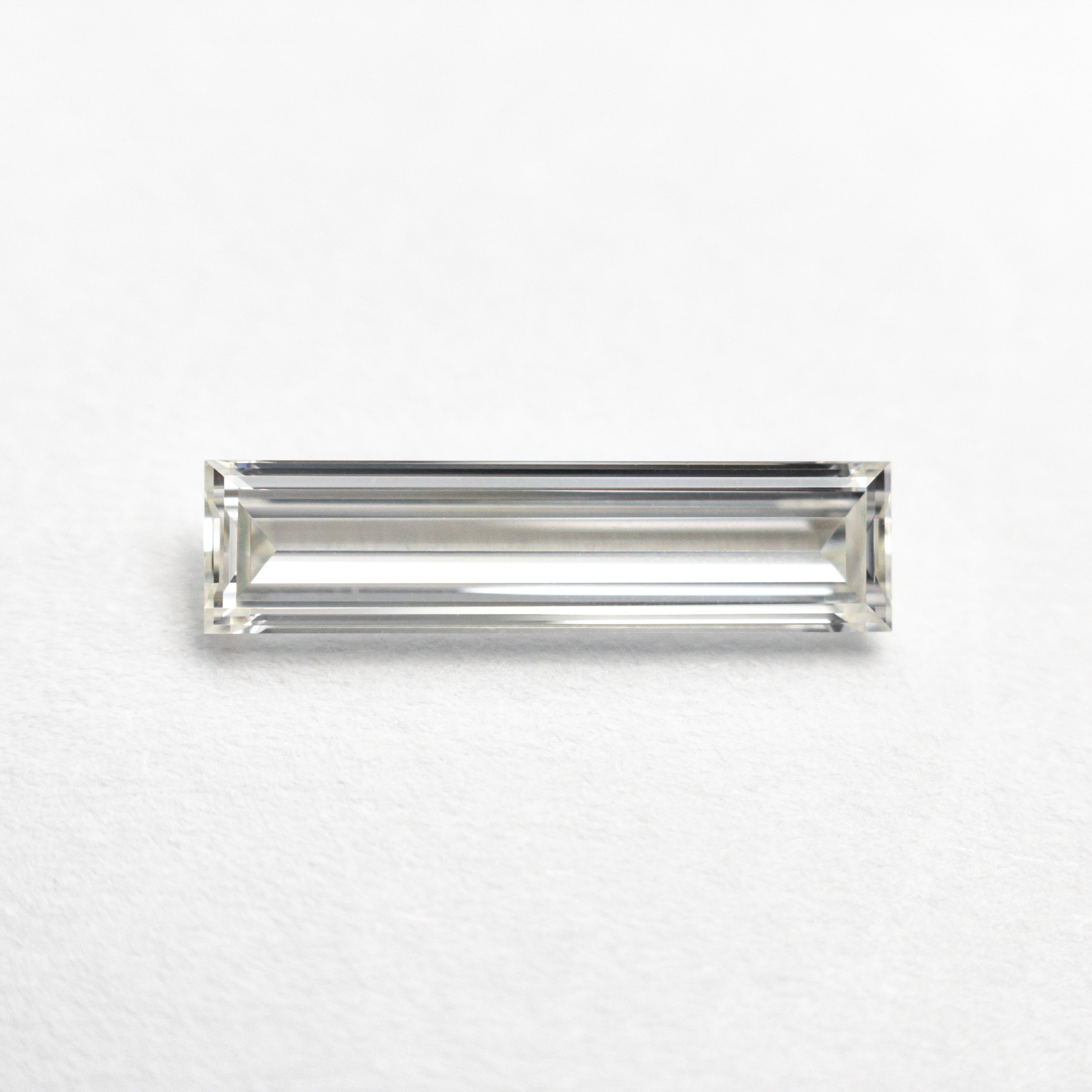 The 0.70ct 11.58x2.89x1.80mm GIA Internally Flawless H Baguette Step Cut 24300-01 by East London jeweller Rachel Boston | Discover our collections of unique and timeless engagement rings, wedding rings, and modern fine jewellery.