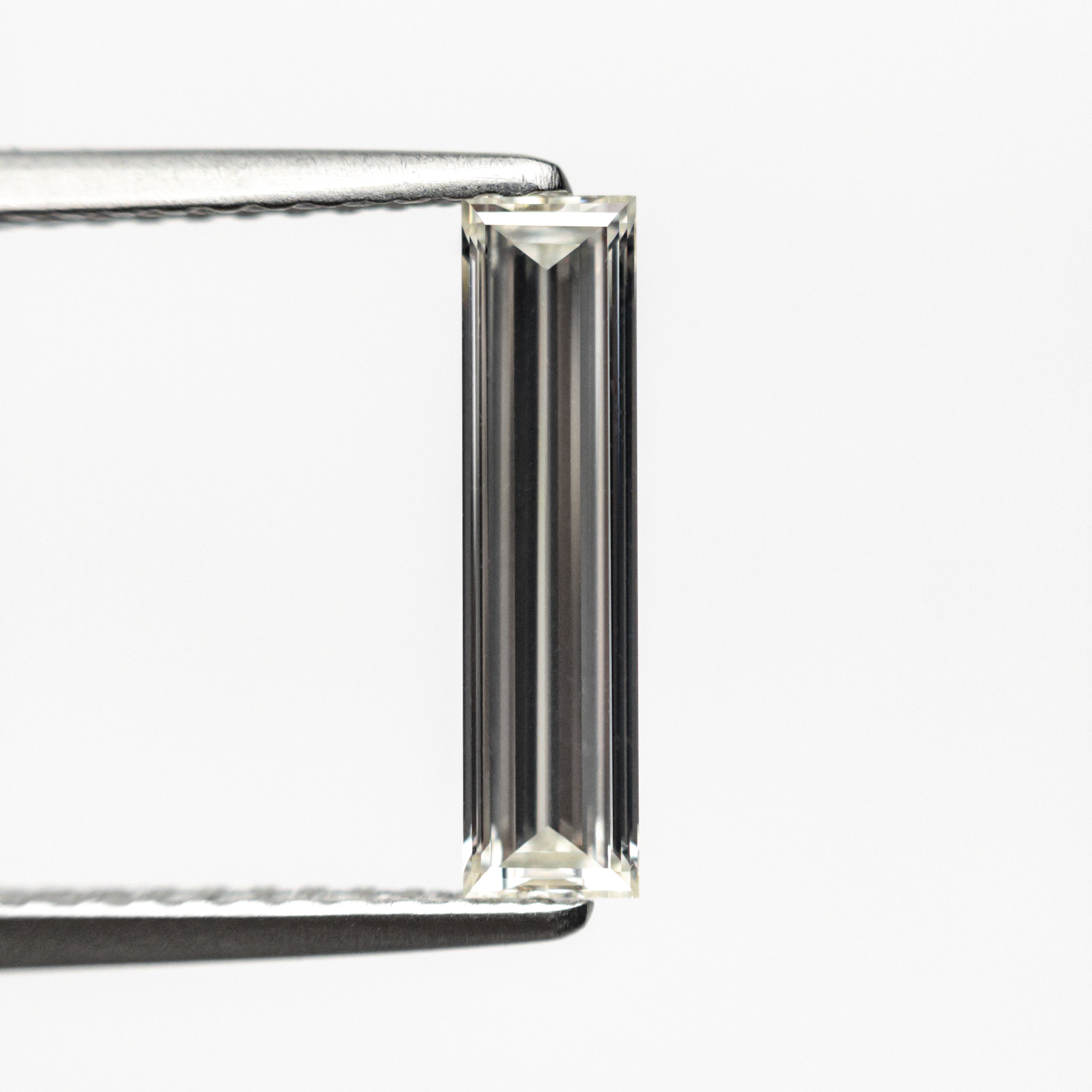 The 0.70ct 11.58x2.89x1.80mm GIA Internally Flawless H Baguette Step Cut 24300-01 by East London jeweller Rachel Boston | Discover our collections of unique and timeless engagement rings, wedding rings, and modern fine jewellery.