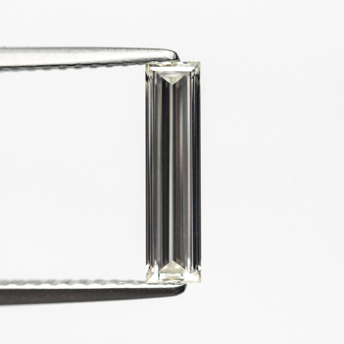 The 0.70ct 11.58x2.89x1.80mm GIA Internally Flawless H Baguette Step Cut 24300-01 by East London jeweller Rachel Boston | Discover our collections of unique and timeless engagement rings, wedding rings, and modern fine jewellery.