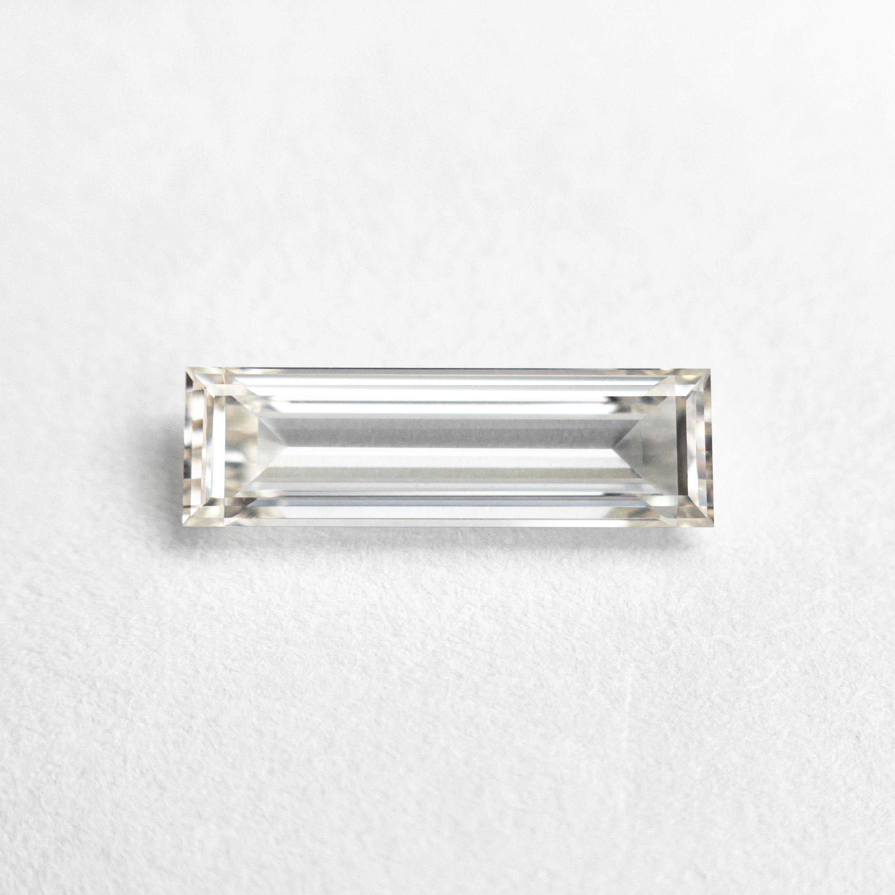 The 0.71ct 10.48x3.17x1.86mm GIA Internally Flawless I Baguette Step Cut 24302-01 by East London jeweller Rachel Boston | Discover our collections of unique and timeless engagement rings, wedding rings, and modern fine jewellery.