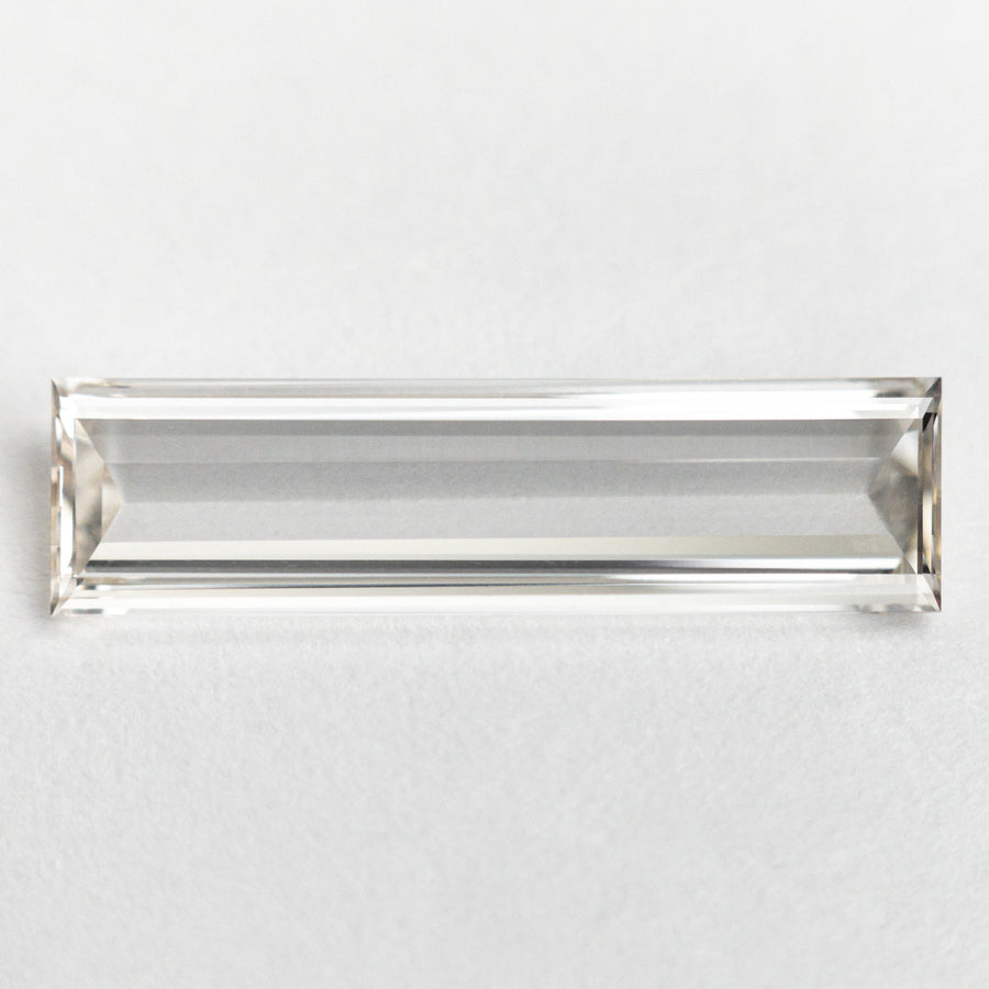 The 1.10ct 15.57x4.14x1.48mm GIA VS1 J Baguette Step Cut 24305-01 by East London jeweller Rachel Boston | Discover our collections of unique and timeless engagement rings, wedding rings, and modern fine jewellery. - Rachel Boston Jewellery