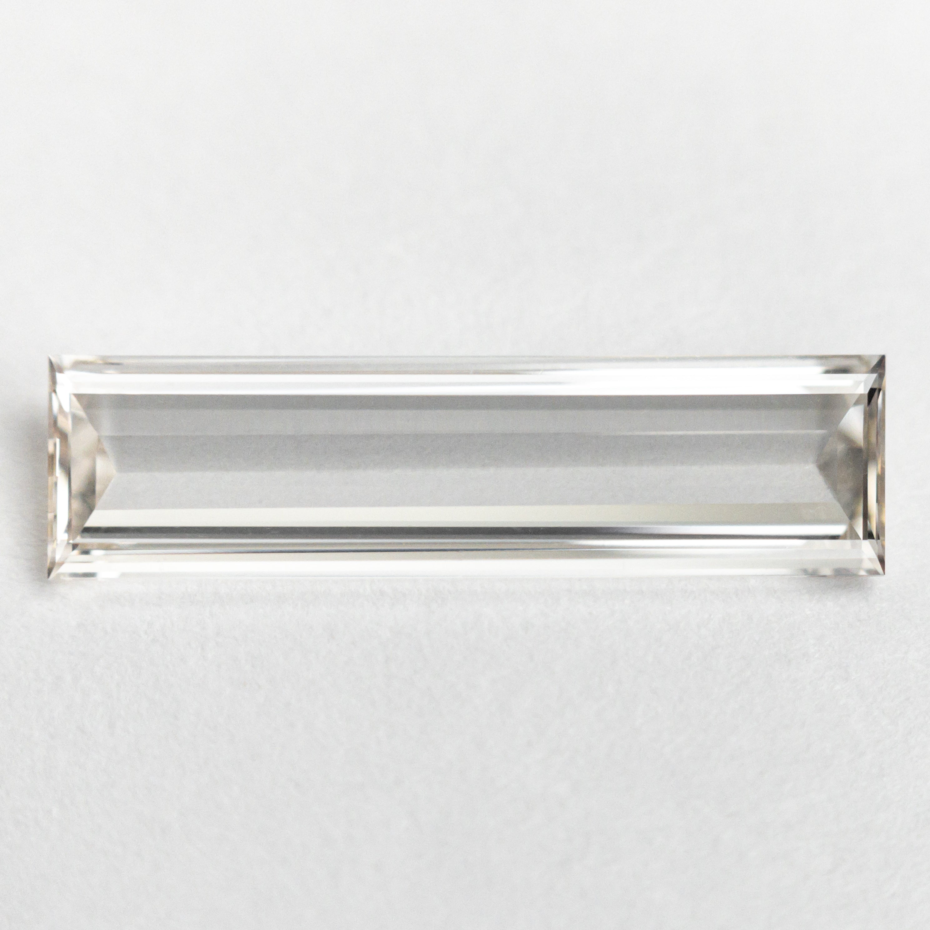 The 1.10ct 15.57x4.14x1.48mm GIA VS1 J Baguette Step Cut 24305-01 by East London jeweller Rachel Boston | Discover our collections of unique and timeless engagement rings, wedding rings, and modern fine jewellery.