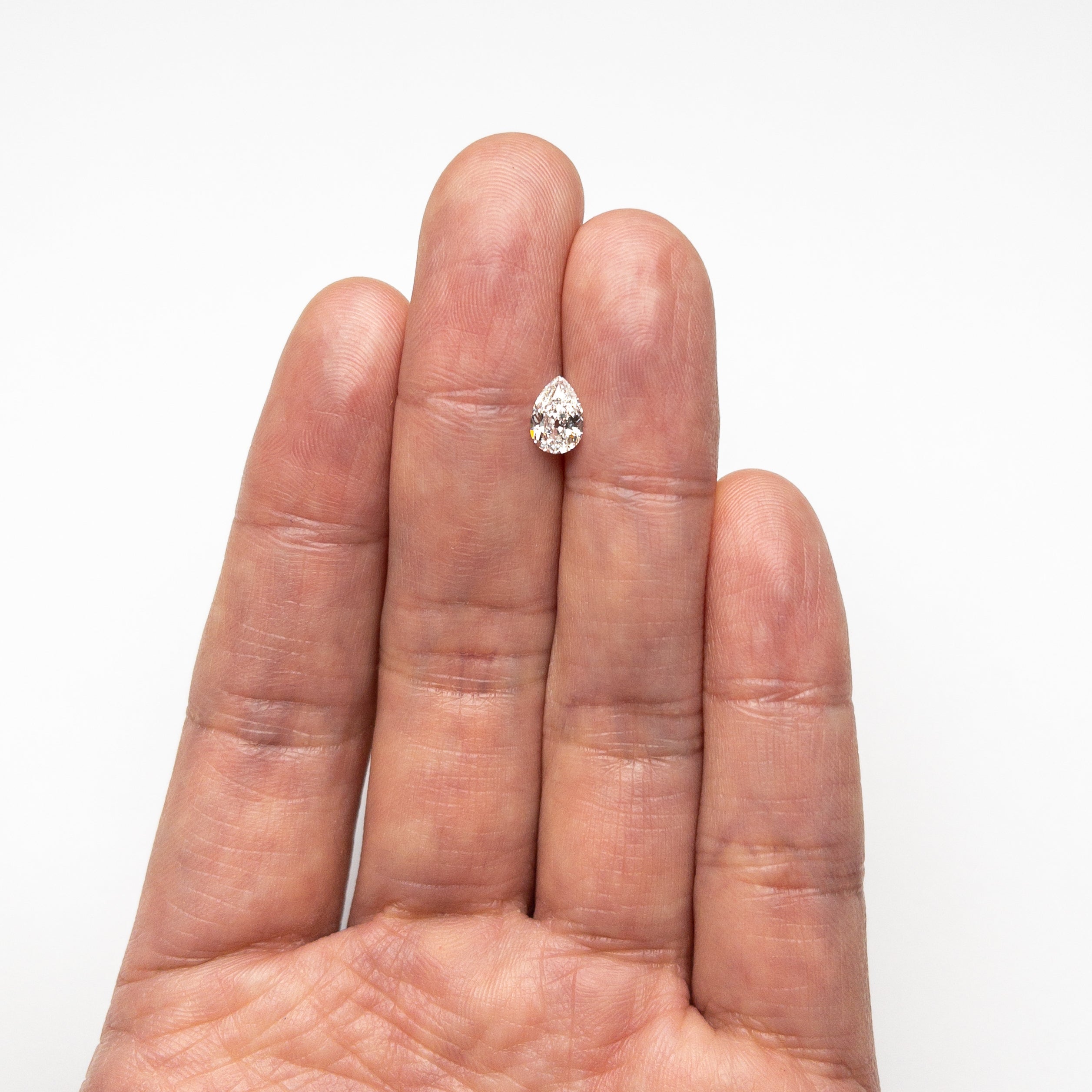 The 0.71ct 7.35x5.03x2.77mm GIA VVS1 F Pear Brilliant 24447-01 by East London jeweller Rachel Boston | Discover our collections of unique and timeless engagement rings, wedding rings, and modern fine jewellery.