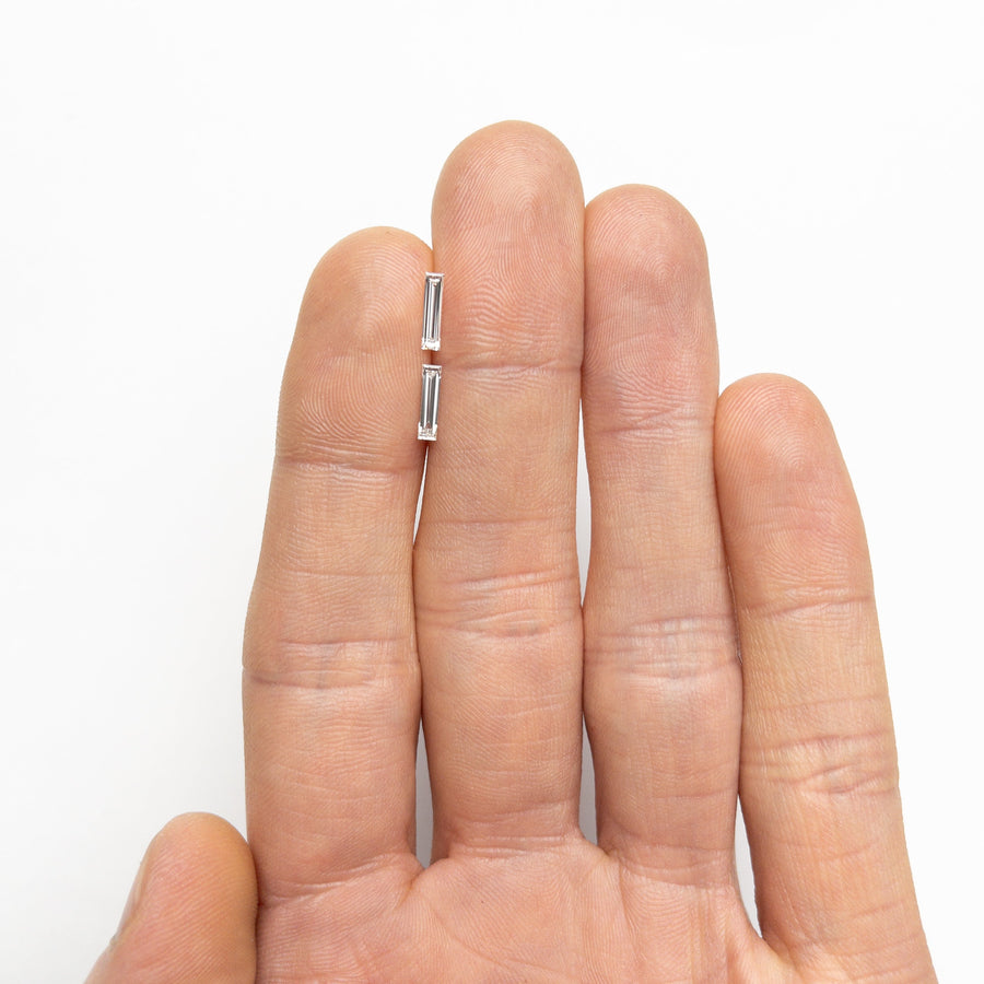 The 0.43cttw 2pc 8.07x1.98x1.22mm 8.07x2.05x1.29mm VS G Baguette Step Cut Matching Pair 24701-01 by East London jeweller Rachel Boston | Discover our collections of unique and timeless engagement rings, wedding rings, and modern fine jewellery. - Rachel Boston Jewellery