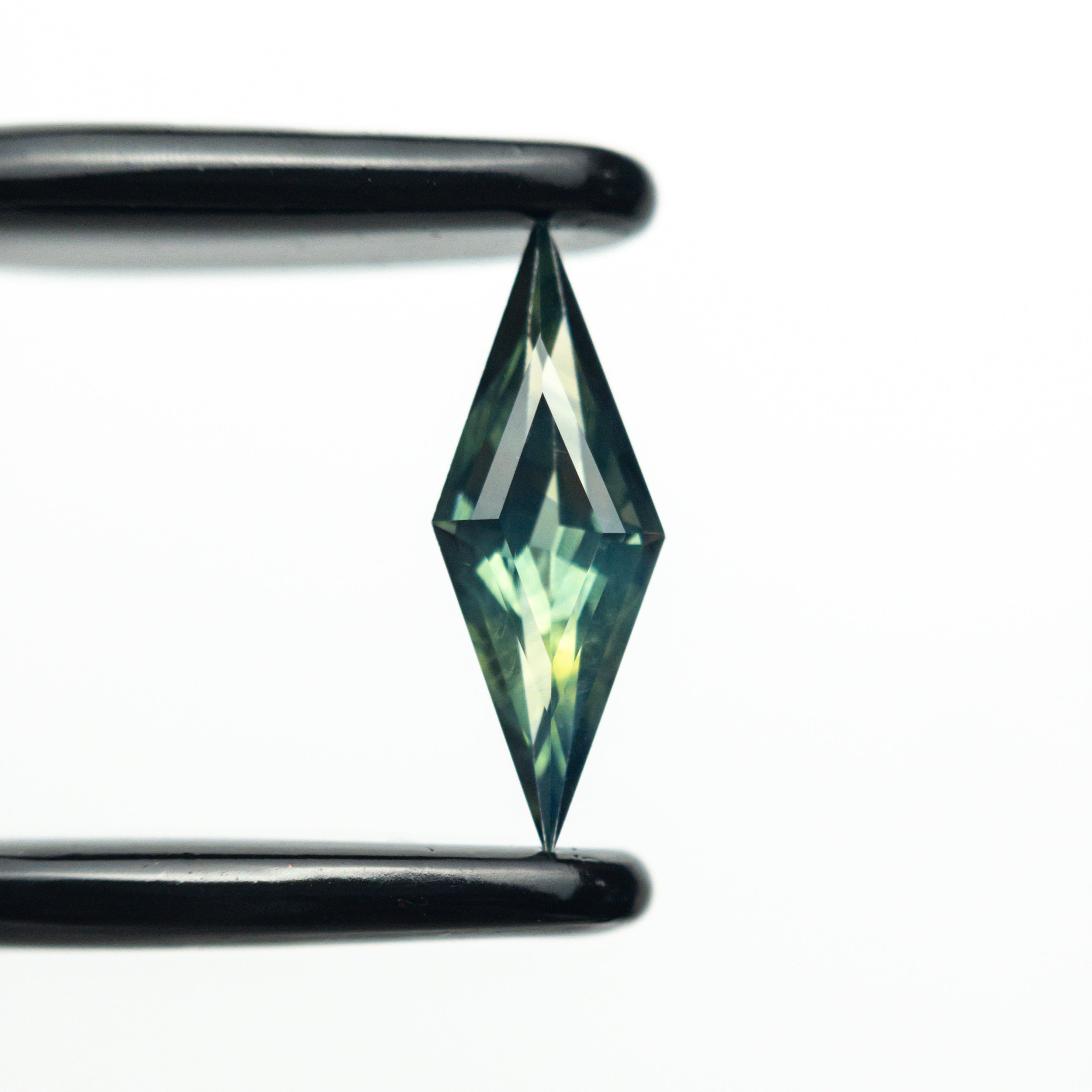The 0.54ct 10.96x4.00x2.56mm Lozenge Step Cut Sapphire 25196-03 by East London jeweller Rachel Boston | Discover our collections of unique and timeless engagement rings, wedding rings, and modern fine jewellery.