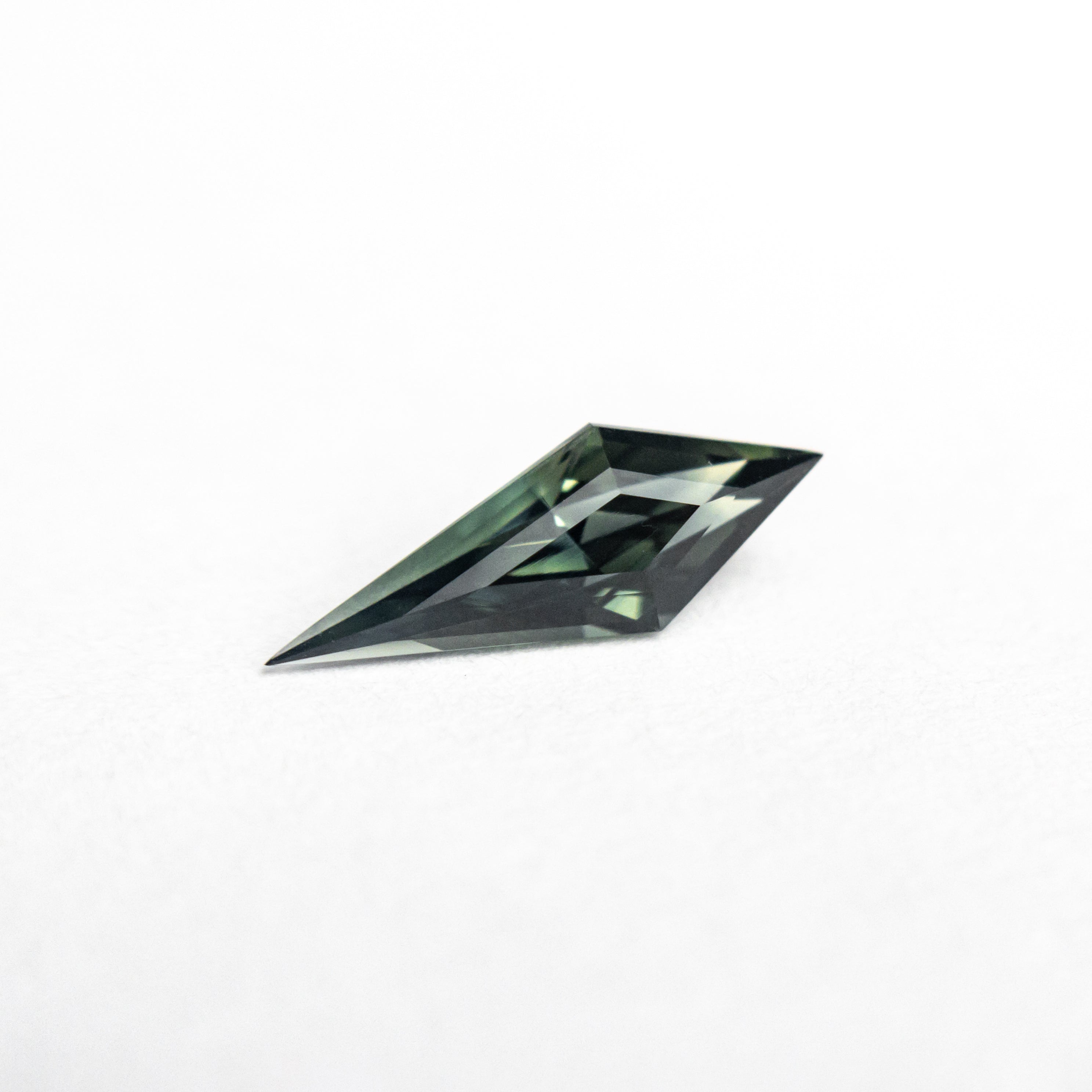 The 0.52ct 10.27x3.70x2.95mm Kite Step Cut Sapphire 25196-05 by East London jeweller Rachel Boston | Discover our collections of unique and timeless engagement rings, wedding rings, and modern fine jewellery.