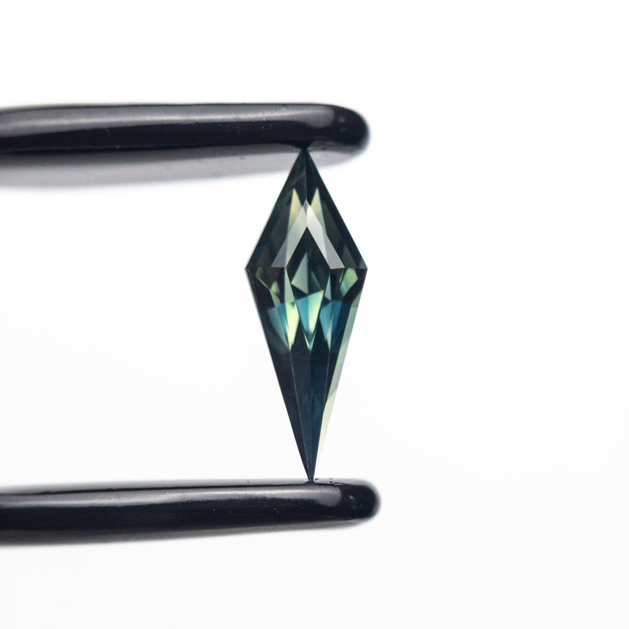 The 0.52ct 10.27x3.70x2.95mm Kite Step Cut Sapphire 25196-05 by East London jeweller Rachel Boston | Discover our collections of unique and timeless engagement rings, wedding rings, and modern fine jewellery. - Rachel Boston Jewellery