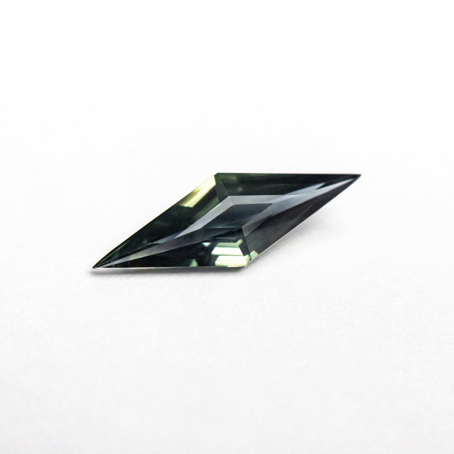 The 0.55ct 11.81x3.99x2.27mm Lozenge Step Cut Sapphire 25196-09 by East London jeweller Rachel Boston | Discover our collections of unique and timeless engagement rings, wedding rings, and modern fine jewellery. - Rachel Boston Jewellery
