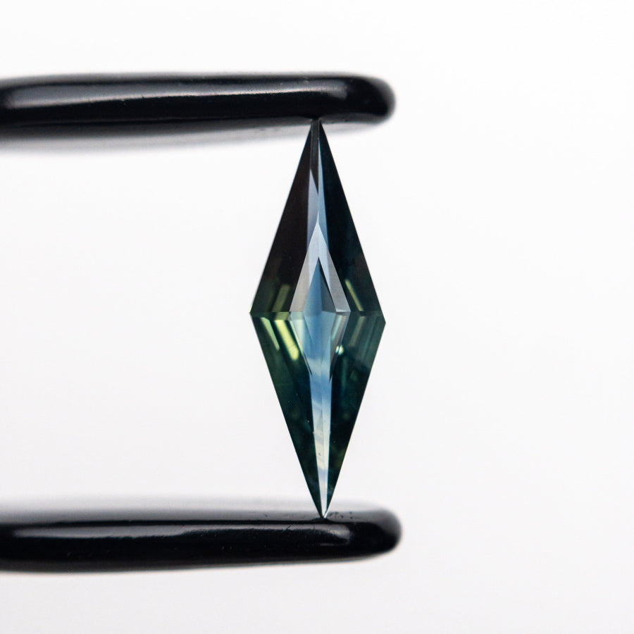 The 0.55ct 11.81x3.99x2.27mm Lozenge Step Cut Sapphire 25196-09 by East London jeweller Rachel Boston | Discover our collections of unique and timeless engagement rings, wedding rings, and modern fine jewellery. - Rachel Boston Jewellery