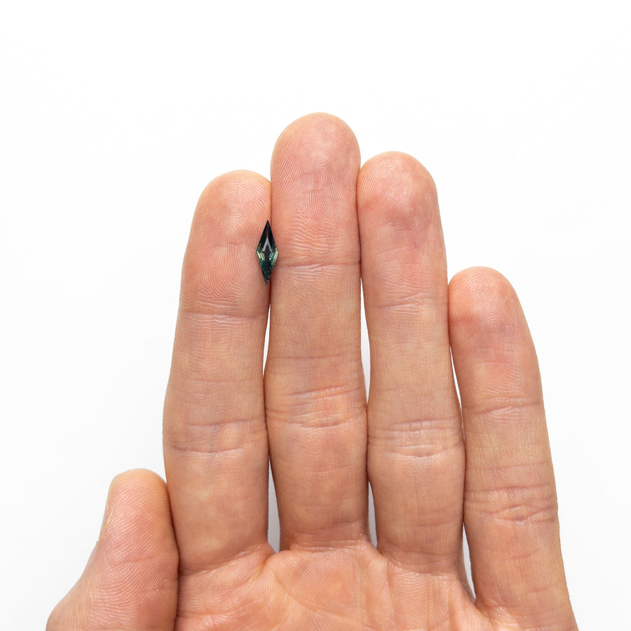 The 0.55ct 11.81x3.99x2.27mm Lozenge Step Cut Sapphire 25196-09 by East London jeweller Rachel Boston | Discover our collections of unique and timeless engagement rings, wedding rings, and modern fine jewellery. - Rachel Boston Jewellery