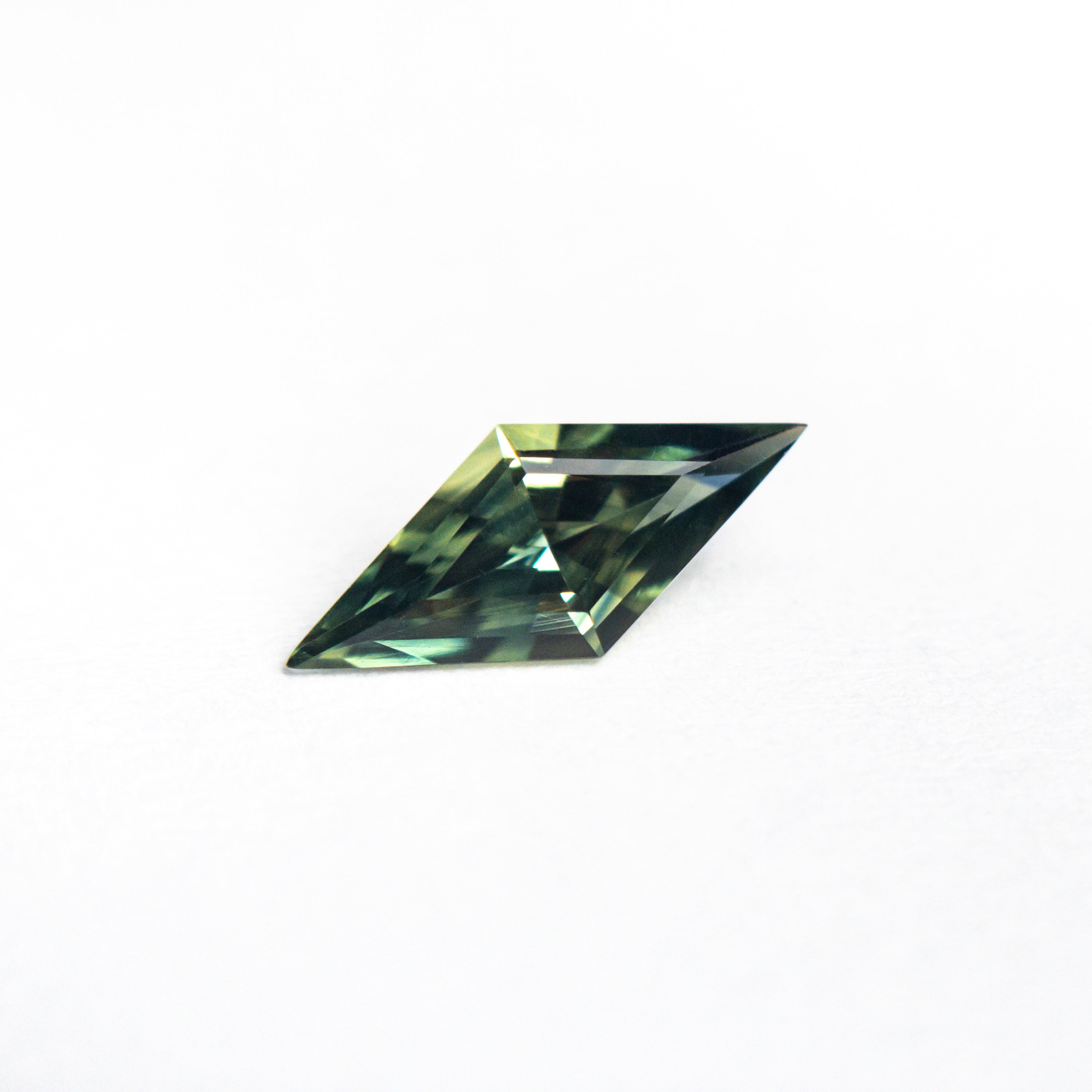 The 0.49ct 9.63x4.21x2.58mm Lozenge Step Cut Sapphire 25197-05 by East London jeweller Rachel Boston | Discover our collections of unique and timeless engagement rings, wedding rings, and modern fine jewellery.