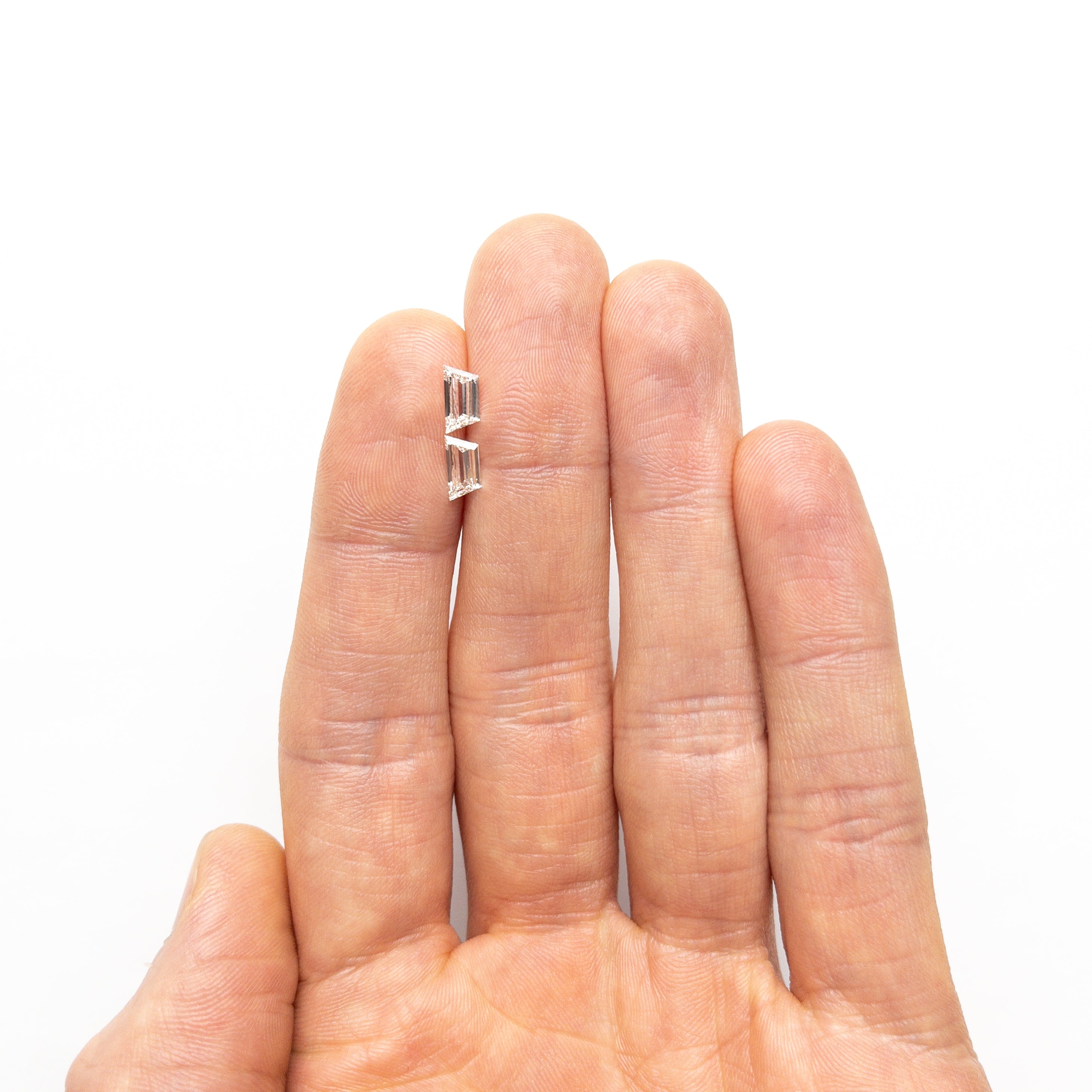 The 1.01cttw 2pc 7.46x3.80x2.00mm 7.37x3.67x2.01mm VVS I Trapezoid Step Cut Matching Pair 25528-01 by East London jeweller Rachel Boston | Discover our collections of unique and timeless engagement rings, wedding rings, and modern fine jewellery.