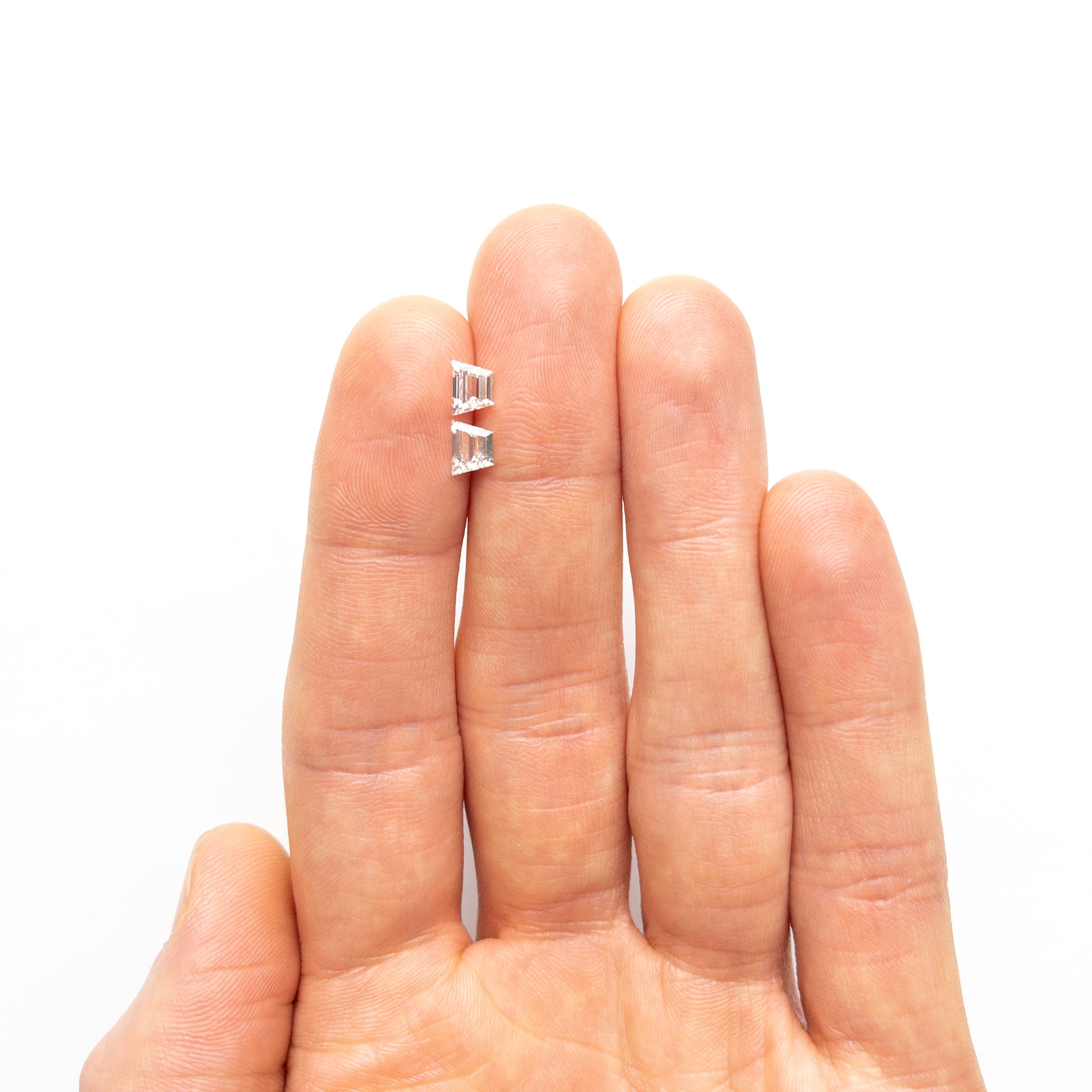 The 1.01cttw 2pc 5.73x4.28x2.53mm 5.83x4.31x2.37mm VVS H Trapezoid Step Cut Matching Pair 25532-01 by East London jeweller Rachel Boston | Discover our collections of unique and timeless engagement rings, wedding rings, and modern fine jewellery.