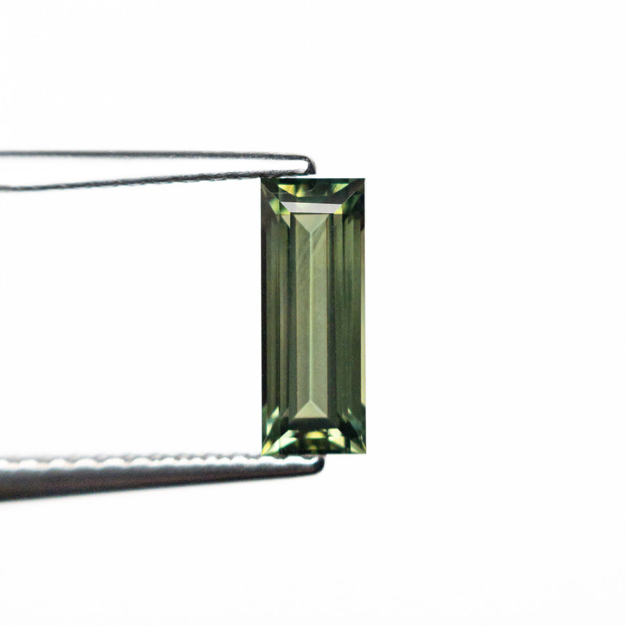 The 0.85ct 8.45x3.22x2.61mm Rectangle Step Cut Sapphire 25740-03 by East London jeweller Rachel Boston | Discover our collections of unique and timeless engagement rings, wedding rings, and modern fine jewellery. - Rachel Boston Jewellery