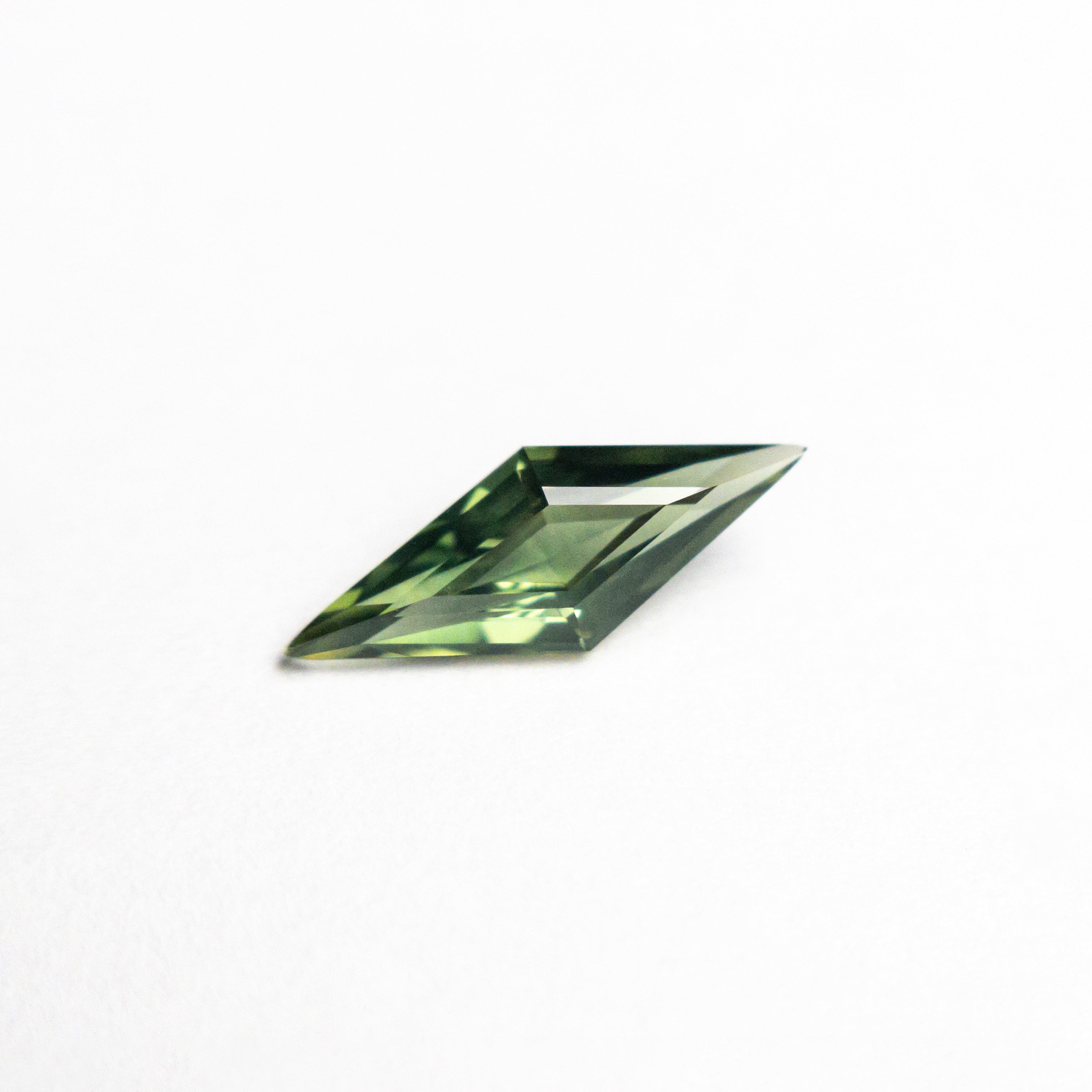 The 0.51ct 9.97x3.79x2.39mm Lozenge Step Cut Sapphire 25740-11 by East London jeweller Rachel Boston | Discover our collections of unique and timeless engagement rings, wedding rings, and modern fine jewellery.