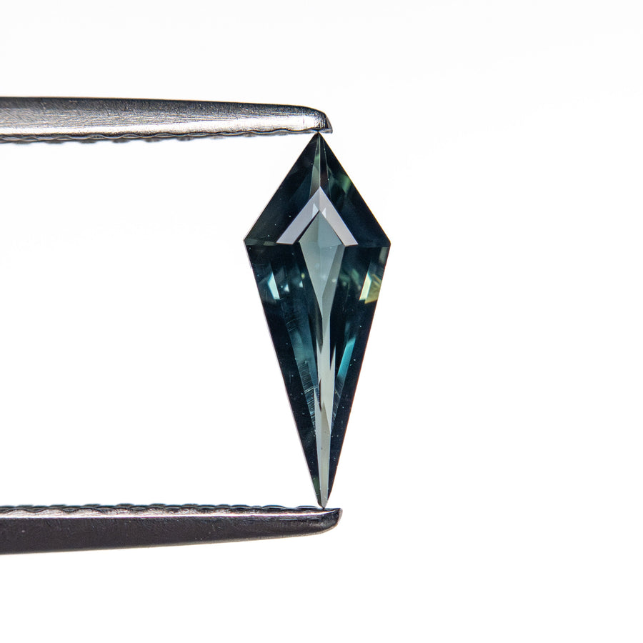 The 0.42ct 9.69x3.83x2.16mm Kite Step Cut Sapphire 25740-21 by East London jeweller Rachel Boston | Discover our collections of unique and timeless engagement rings, wedding rings, and modern fine jewellery. - Rachel Boston Jewellery