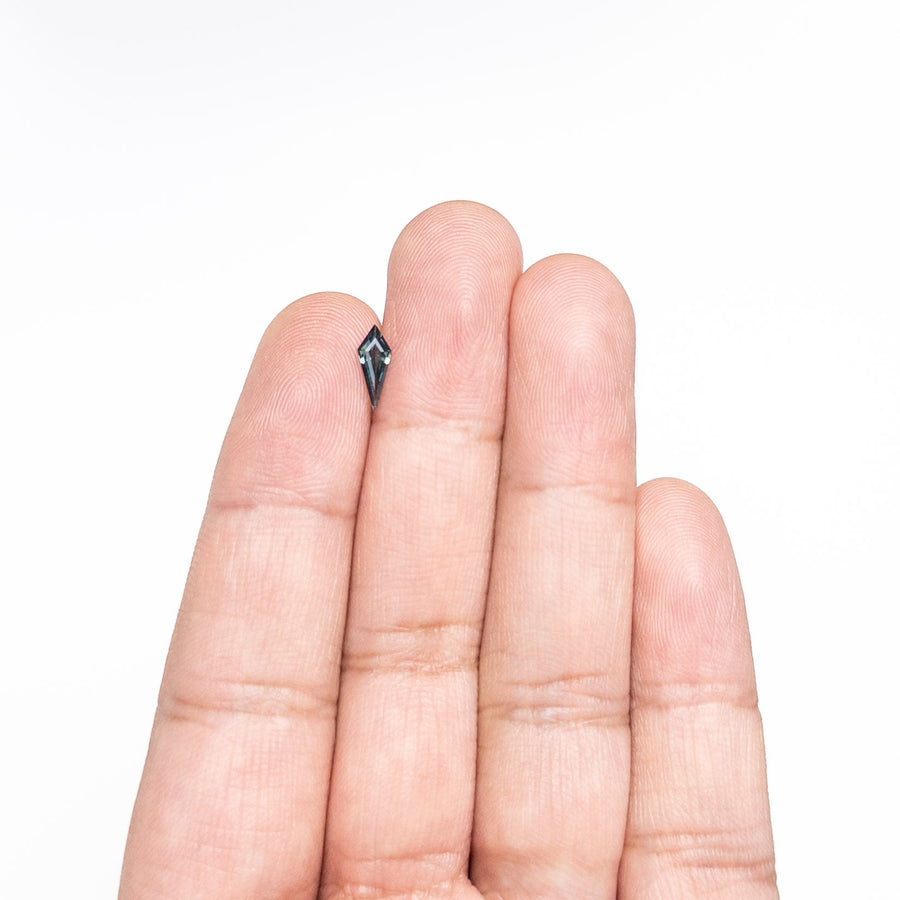 The 0.42ct 9.69x3.83x2.16mm Kite Step Cut Sapphire 25740-21 by East London jeweller Rachel Boston | Discover our collections of unique and timeless engagement rings, wedding rings, and modern fine jewellery. - Rachel Boston Jewellery