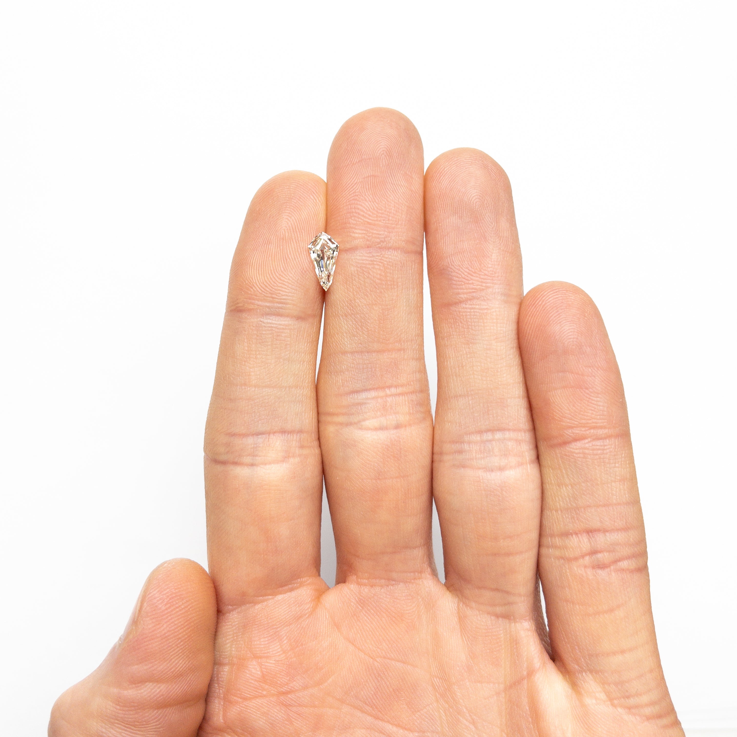 The 0.91ct 9.95x5.23x2.88mm SI1 K Shield Step Cut 25955-01 by East London jeweller Rachel Boston | Discover our collections of unique and timeless engagement rings, wedding rings, and modern fine jewellery.