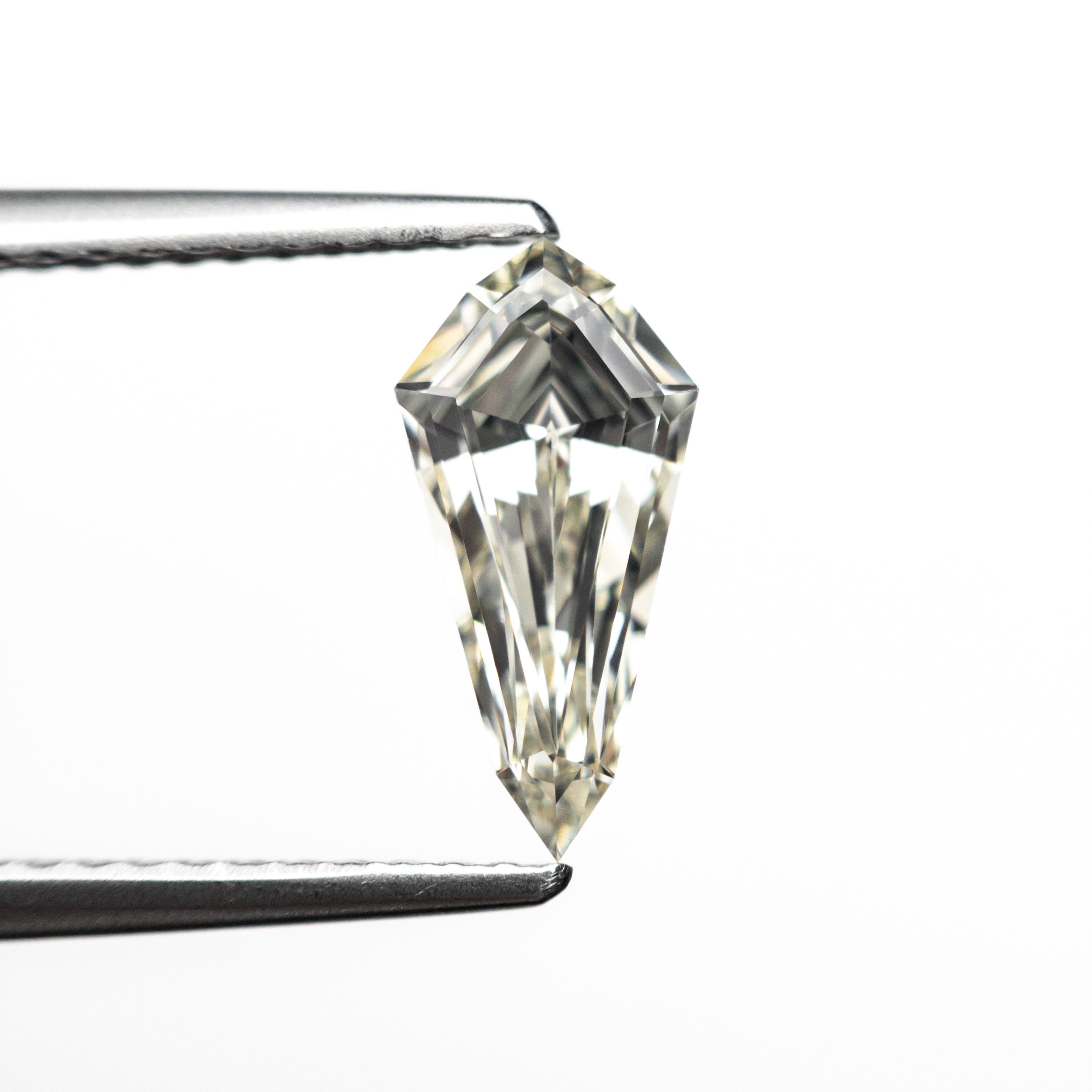 The 1.05ct 10.63x5.20x3.32mm VS1 M-N Shield Step Cut 25956-01 by East London jeweller Rachel Boston | Discover our collections of unique and timeless engagement rings, wedding rings, and modern fine jewellery.