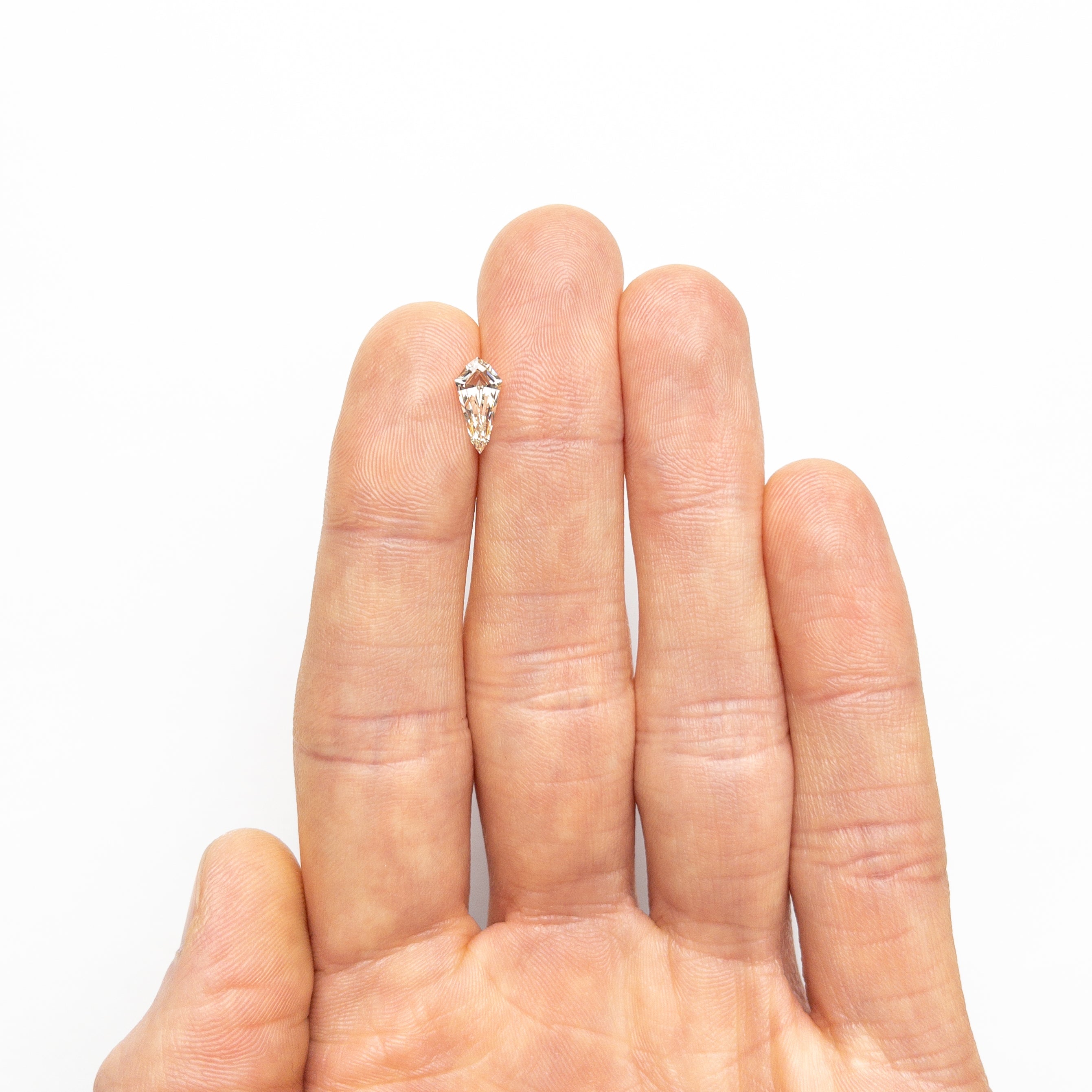 The 1.05ct 10.63x5.20x3.32mm VS1 M-N Shield Step Cut 25956-01 by East London jeweller Rachel Boston | Discover our collections of unique and timeless engagement rings, wedding rings, and modern fine jewellery.