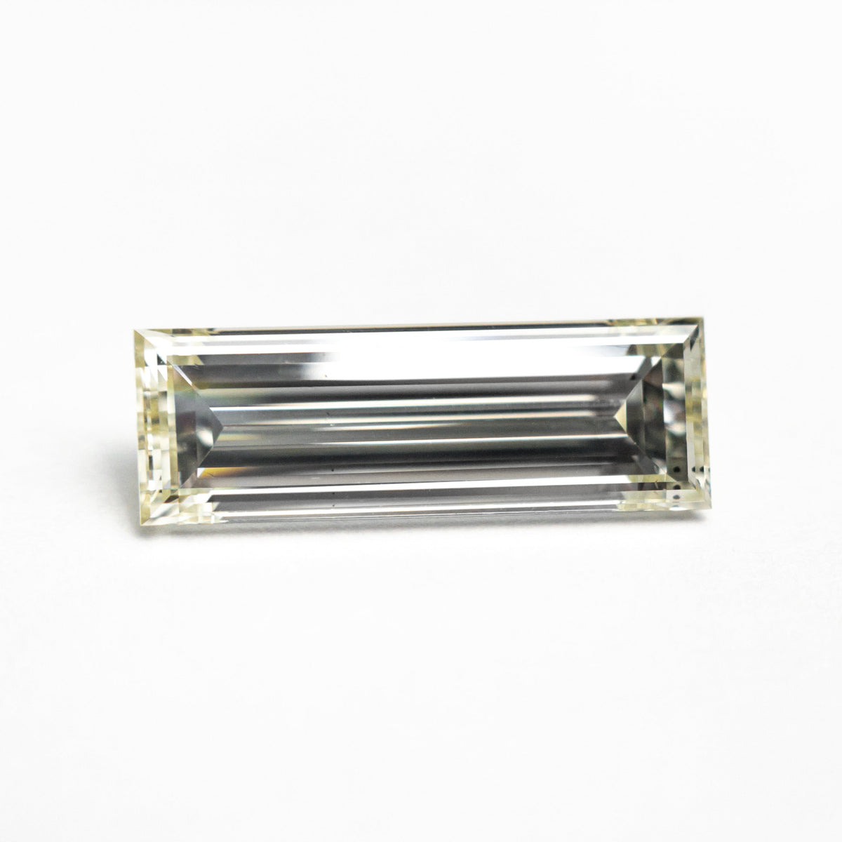 The 1.52ct 12.21x4.16x2.86mm VS2 O-P Baguette Step Cut 26124-01 by East London jeweller Rachel Boston | Discover our collections of unique and timeless engagement rings, wedding rings, and modern fine jewellery.