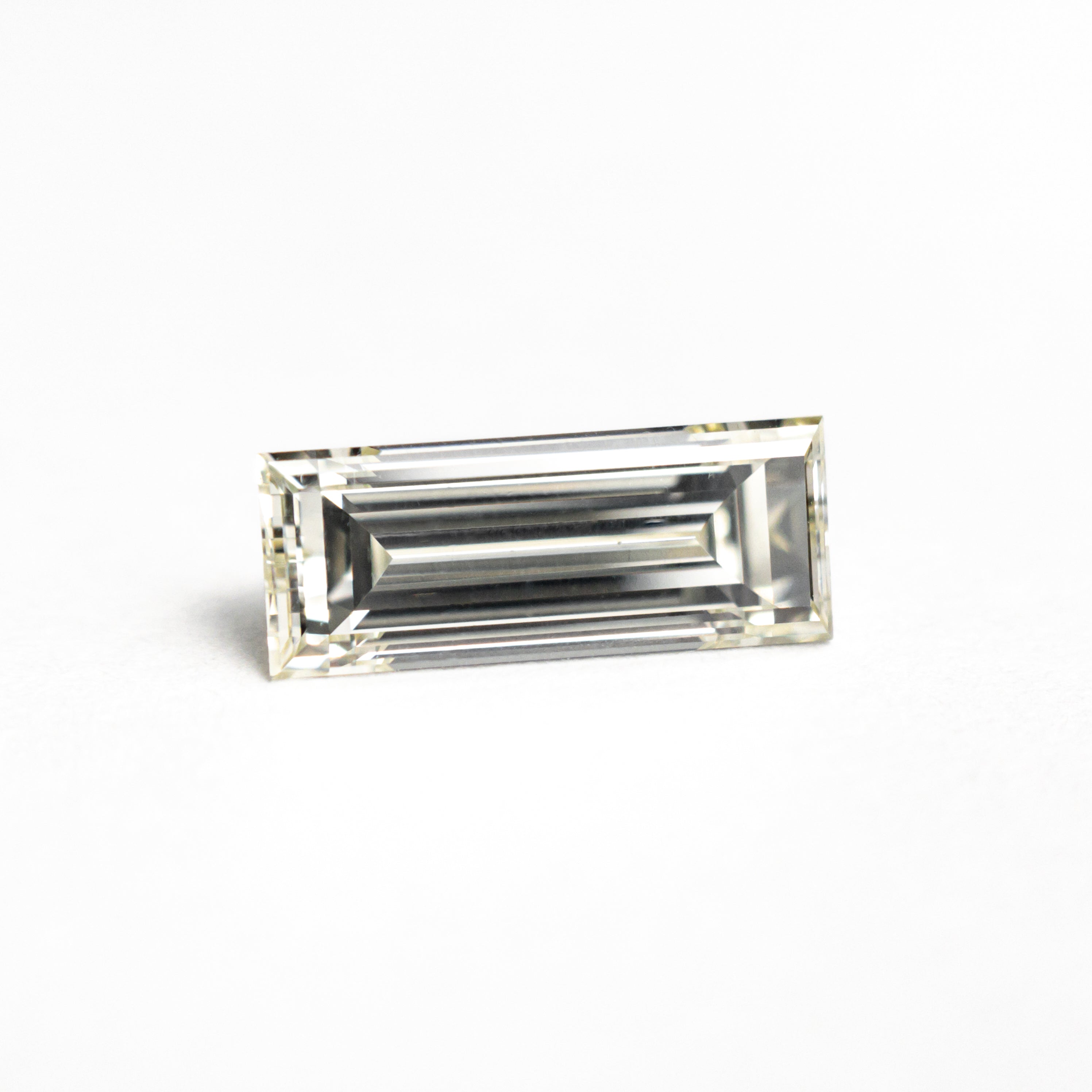 The 1.11ct 9.55x3.80x2.97mm VS2 O-P Baguette Step Cut 26124-02 by East London jeweller Rachel Boston | Discover our collections of unique and timeless engagement rings, wedding rings, and modern fine jewellery.
