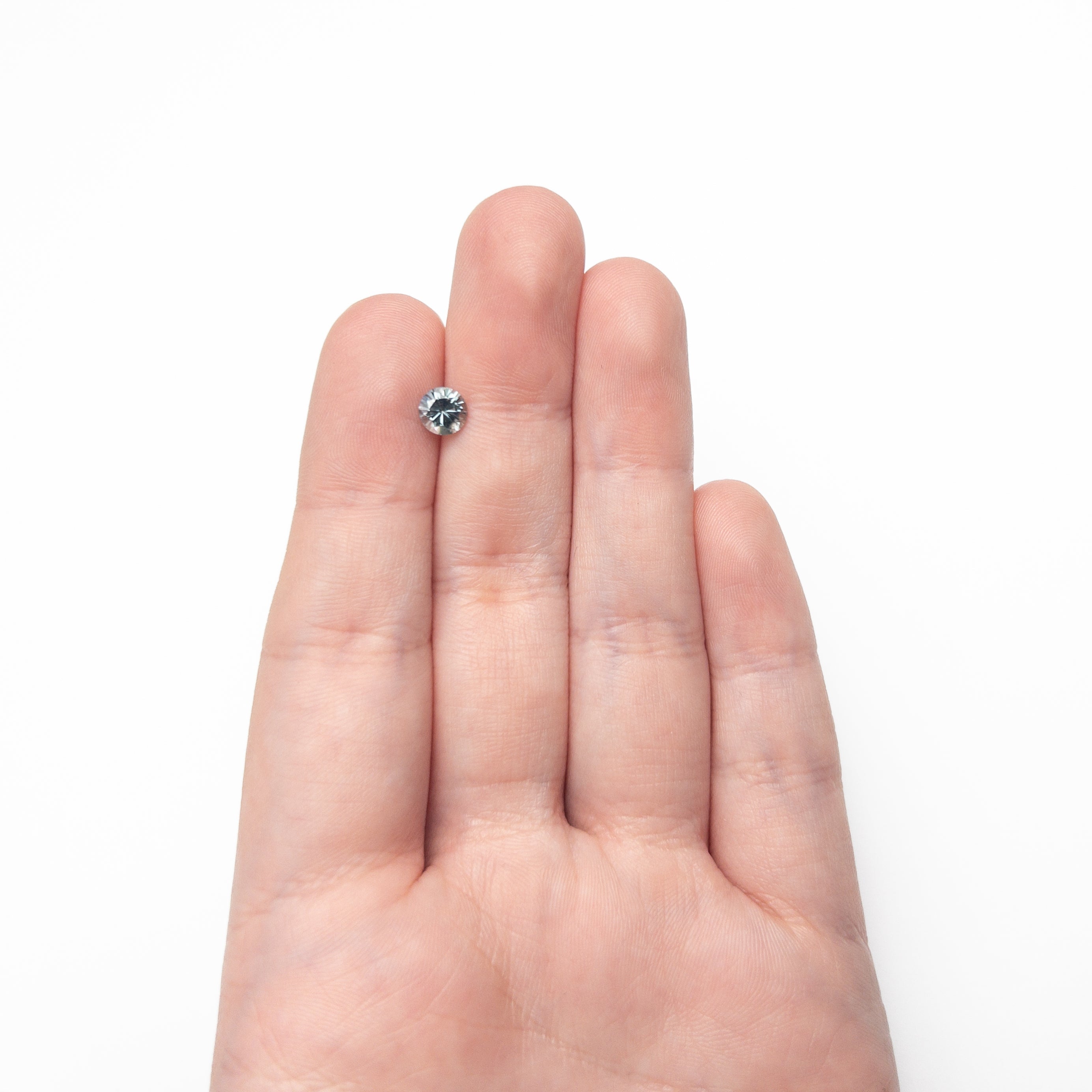 The 0.81ct 5.54x5.52x3.69mm Round Brilliant Sapphire 26134-04 by East London jeweller Rachel Boston | Discover our collections of unique and timeless engagement rings, wedding rings, and modern fine jewellery.