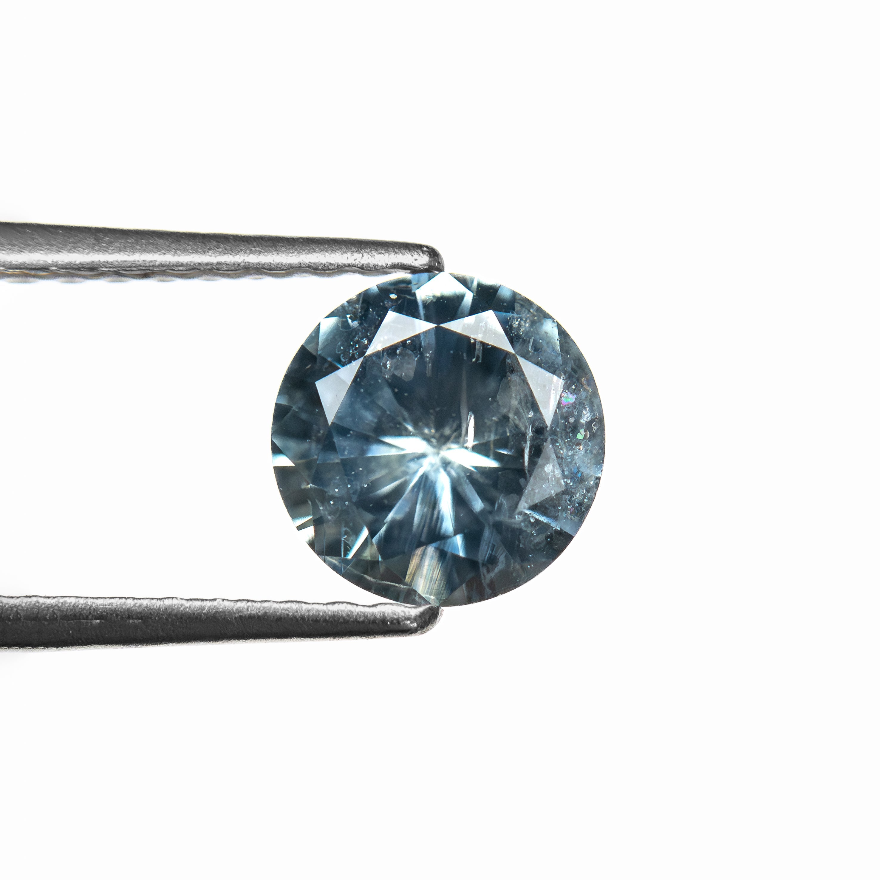 The 1.00ct 6.07x6.04x3.74mm Round Brilliant Sapphire 26141-23 by East London jeweller Rachel Boston | Discover our collections of unique and timeless engagement rings, wedding rings, and modern fine jewellery.