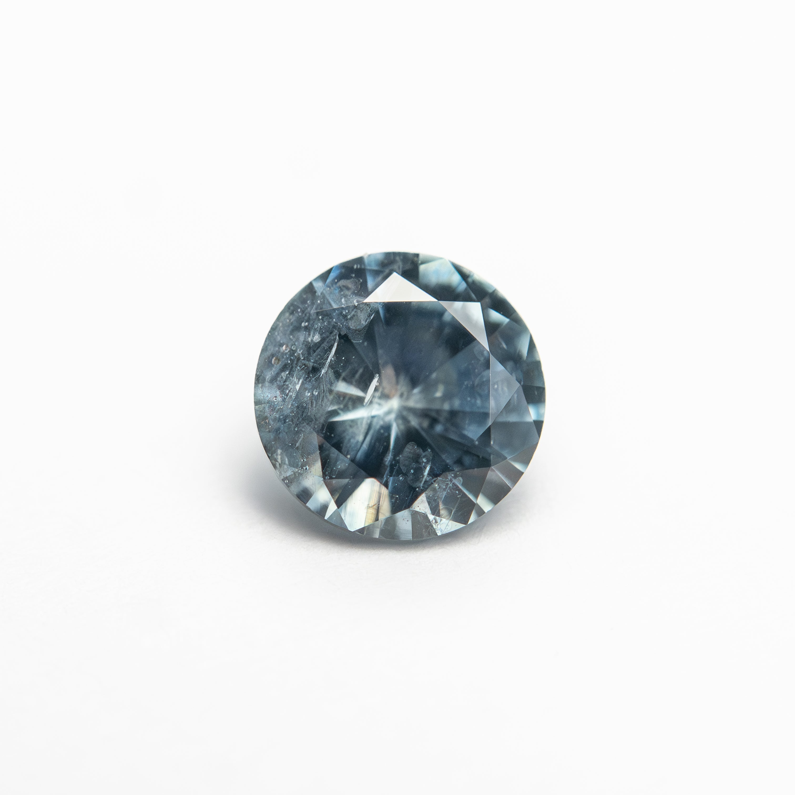 The 1.00ct 6.07x6.04x3.74mm Round Brilliant Sapphire 26141-23 by East London jeweller Rachel Boston | Discover our collections of unique and timeless engagement rings, wedding rings, and modern fine jewellery.