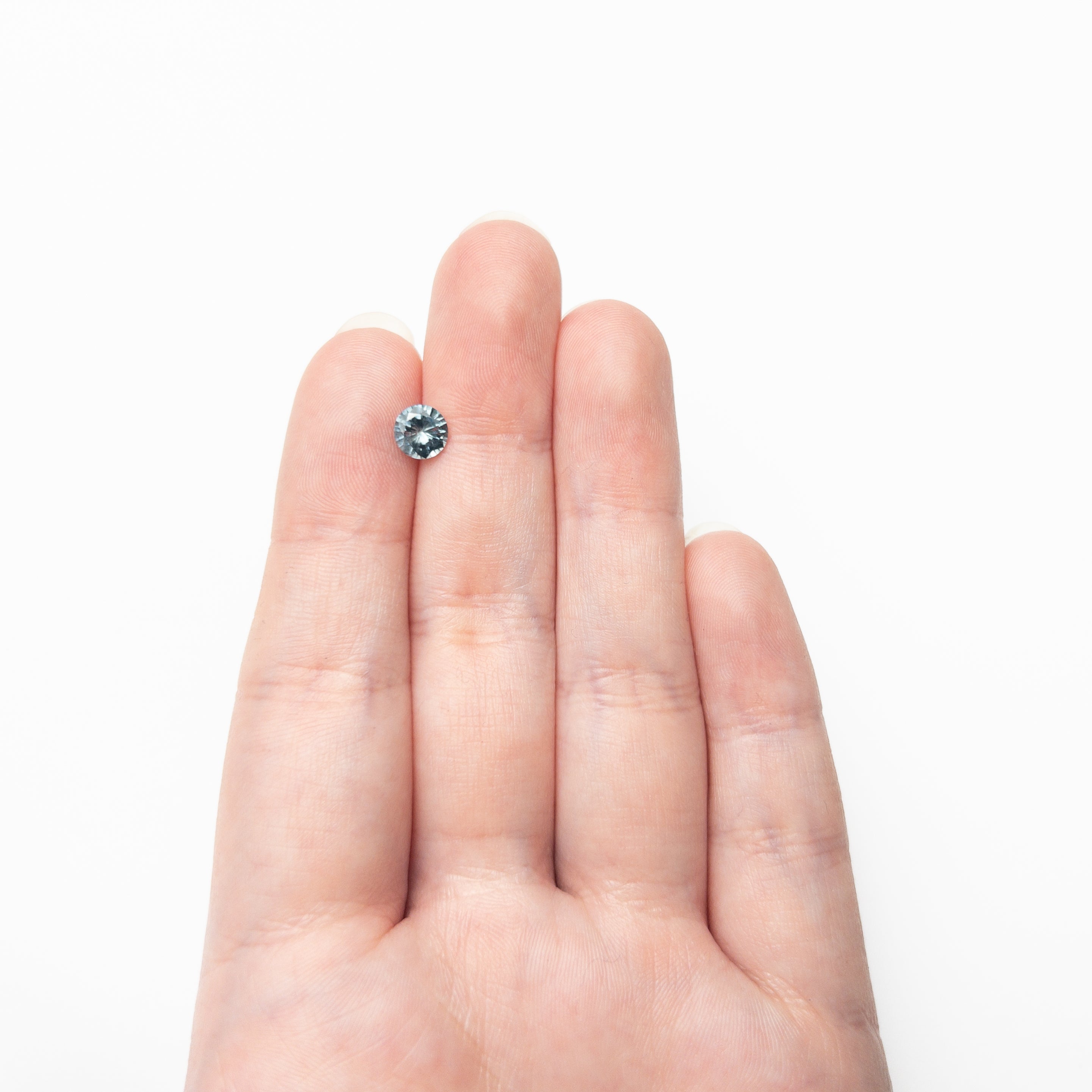 The 1.00ct 6.07x6.04x3.74mm Round Brilliant Sapphire 26141-23 by East London jeweller Rachel Boston | Discover our collections of unique and timeless engagement rings, wedding rings, and modern fine jewellery.