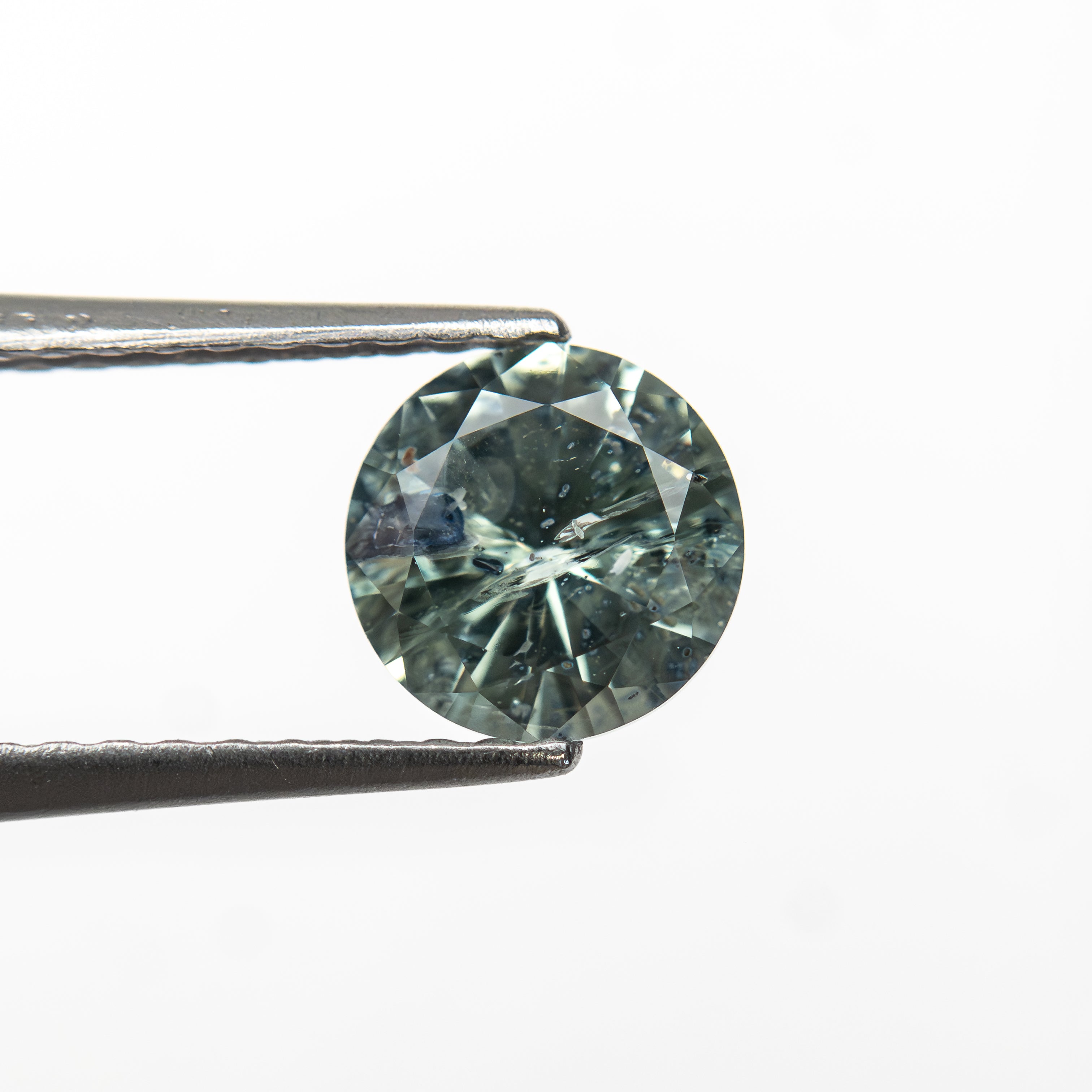 The 1.00ct 6.05x6.01x3.73mm Round Brilliant Sapphire 26141-28 by East London jeweller Rachel Boston | Discover our collections of unique and timeless engagement rings, wedding rings, and modern fine jewellery.