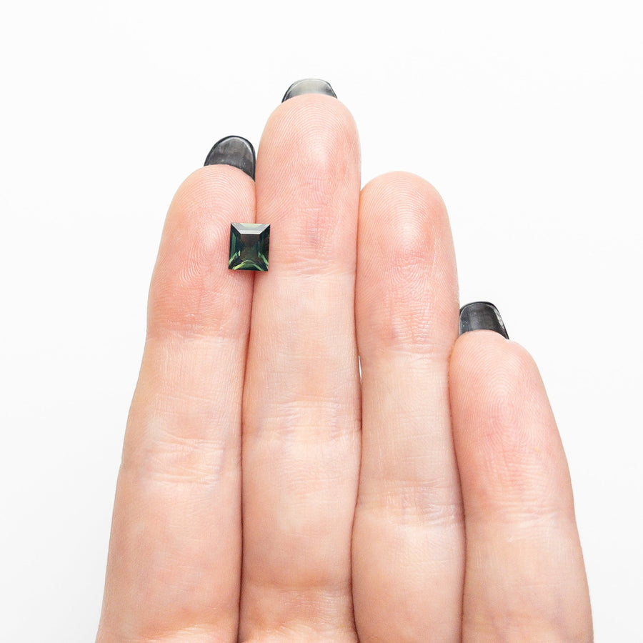 The 0.96ct 6.15x5.21x3.17mm Rectangle Step Cut Sapphire 26495-01 by East London jeweller Rachel Boston | Discover our collections of unique and timeless engagement rings, wedding rings, and modern fine jewellery. - Rachel Boston Jewellery