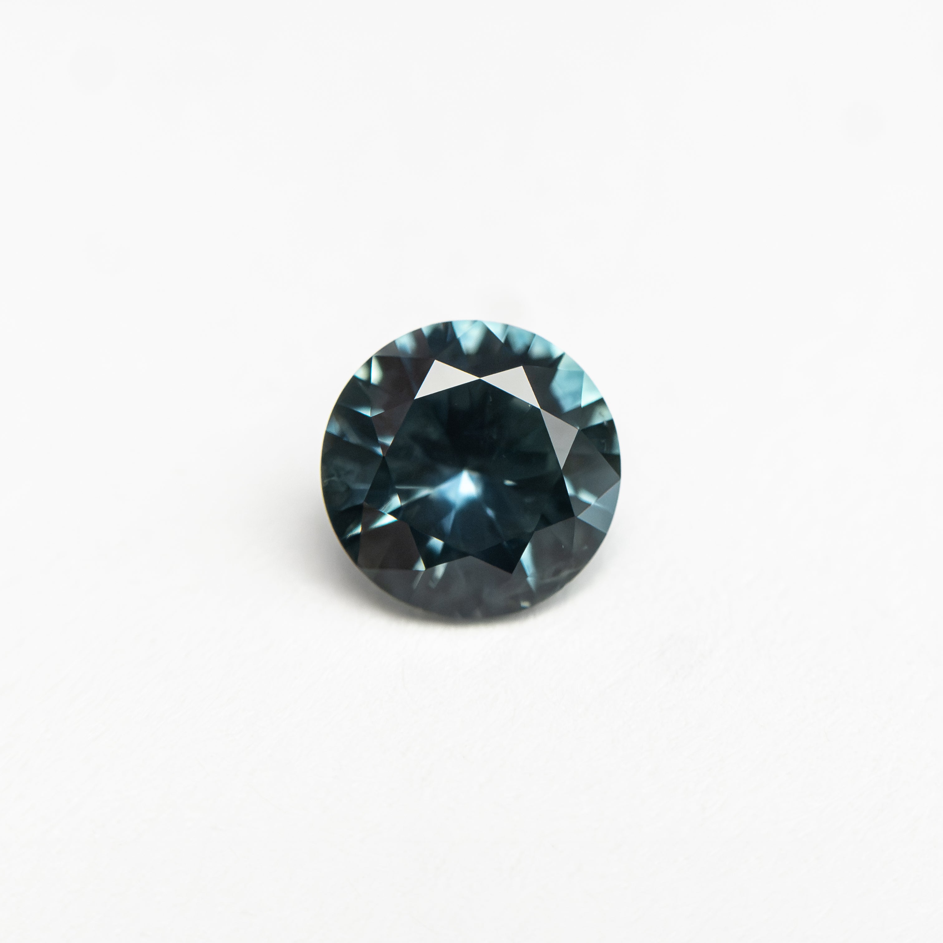 The 0.63ct 5.5.28x5.27x3.12mm Round Brilliant Sapphire 26526-10 by East London jeweller Rachel Boston | Discover our collections of unique and timeless engagement rings, wedding rings, and modern fine jewellery.