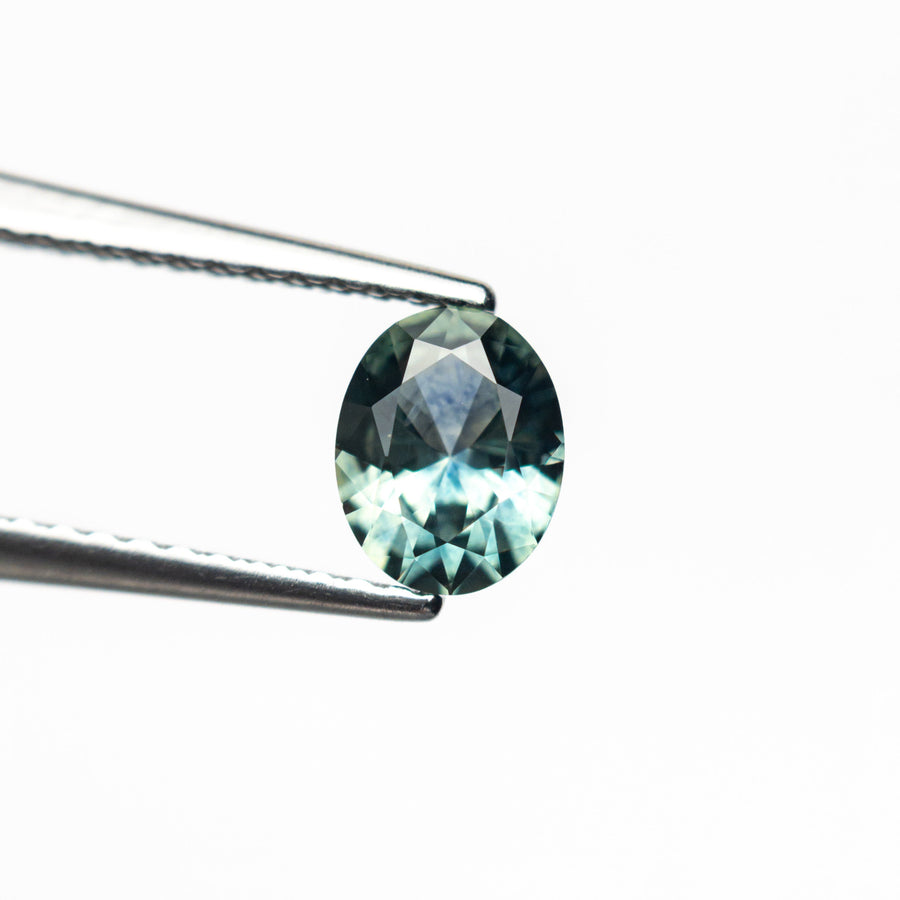 The 0.66ct 6.08x4.80x2.94mm Oval Brilliant Sapphire 26668-04 by East London jeweller Rachel Boston | Discover our collections of unique and timeless engagement rings, wedding rings, and modern fine jewellery. - Rachel Boston Jewellery